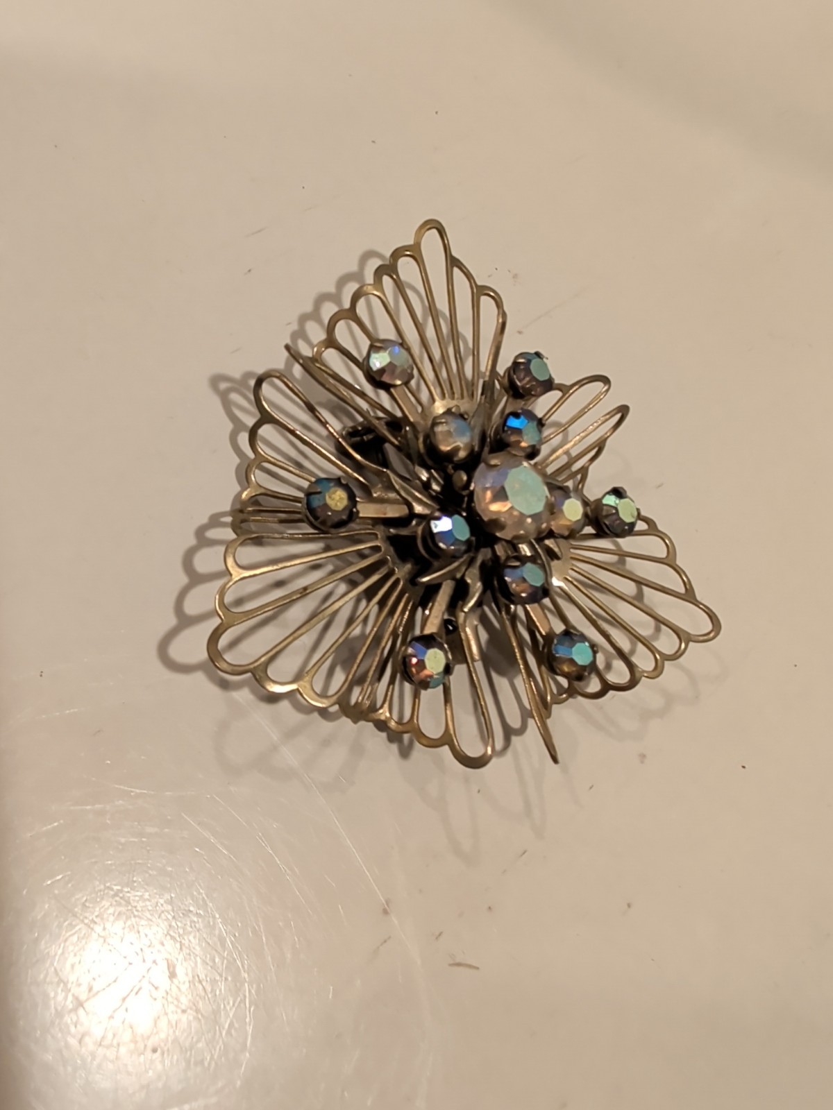 Vintage Coro or Kramer starburst brooch with aurora borealis rhinestones. USA.
