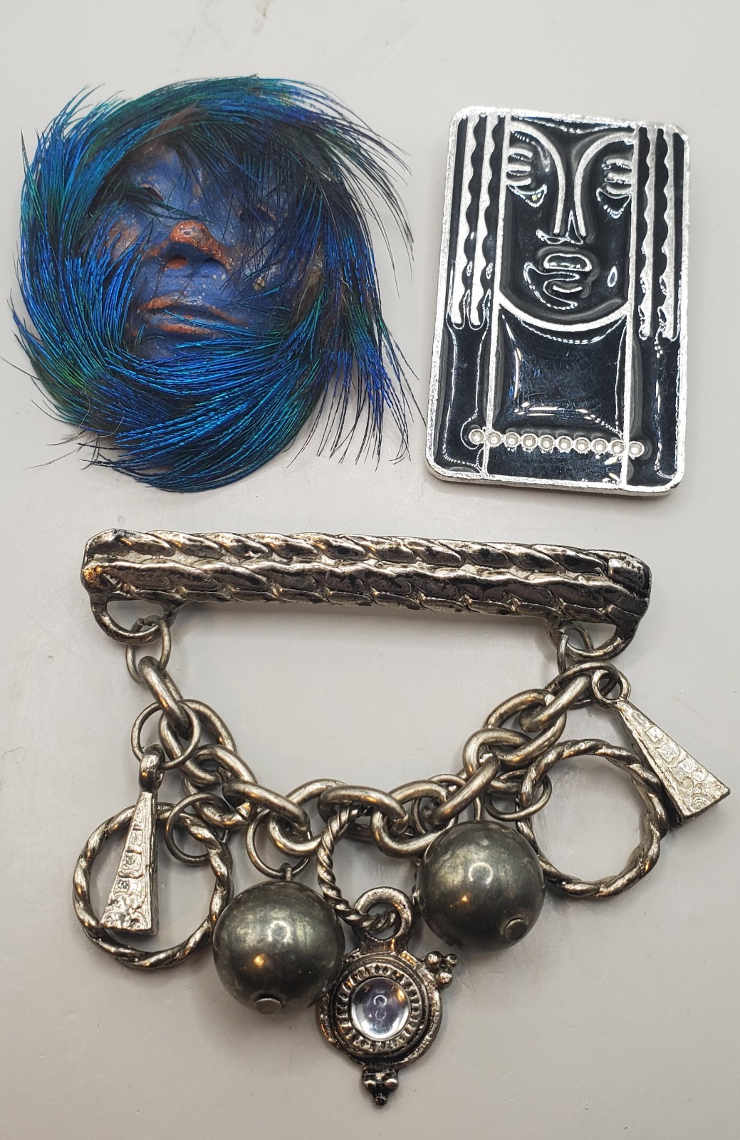 3 Brooches: Tribal Peacock Feather Clay Mask, RITZ Pewter Face, Bar W/ Charms