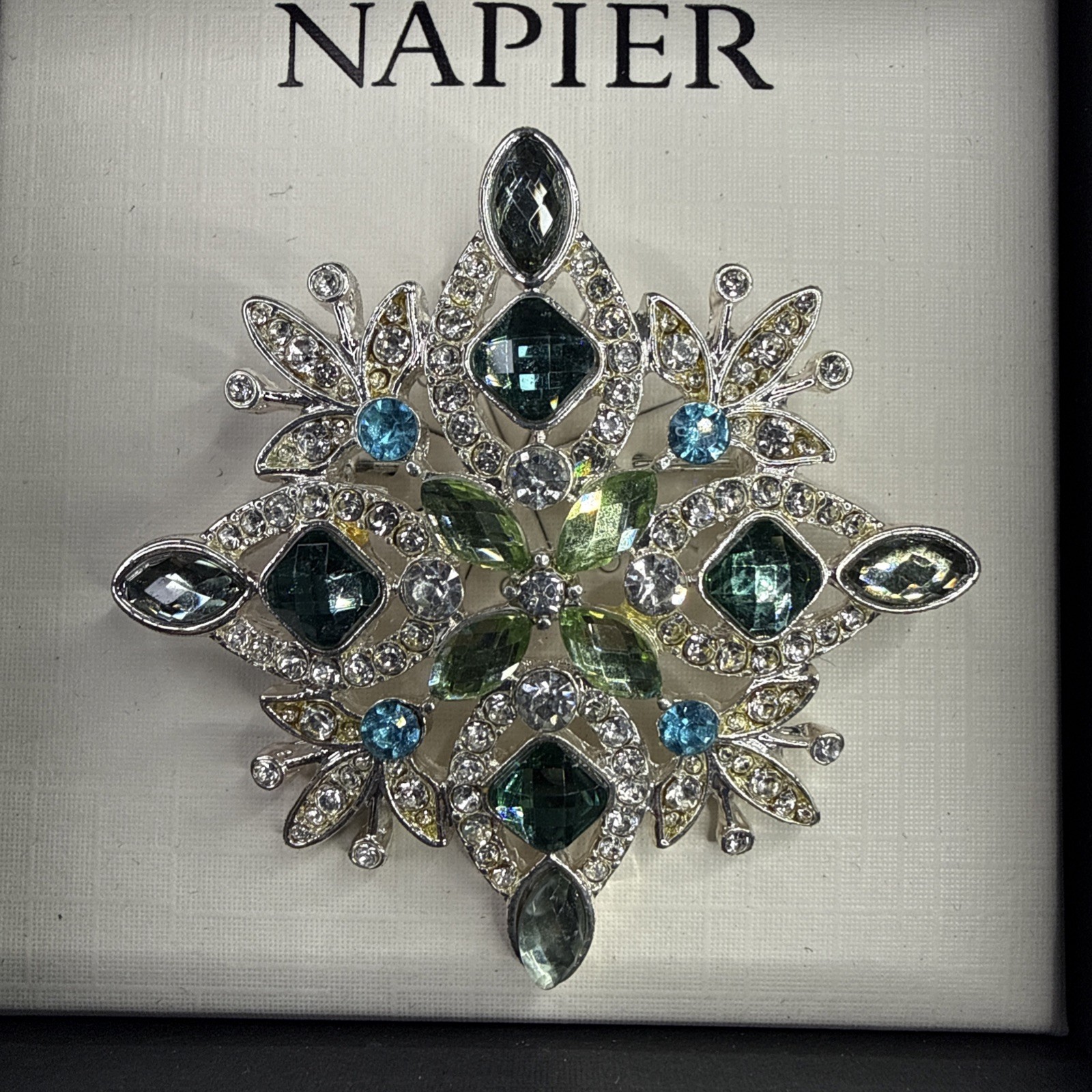 Napier silver-tone snowflake pin/brooch featuring blue and green rhinestones NOS