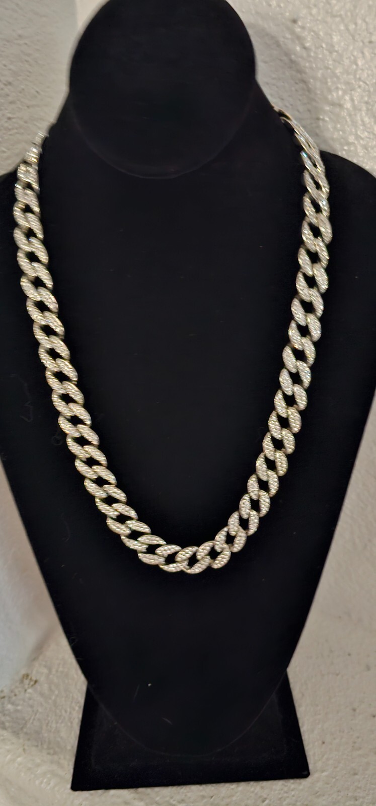 Cuban chain necklace silver tone one side many crystals other side plain.