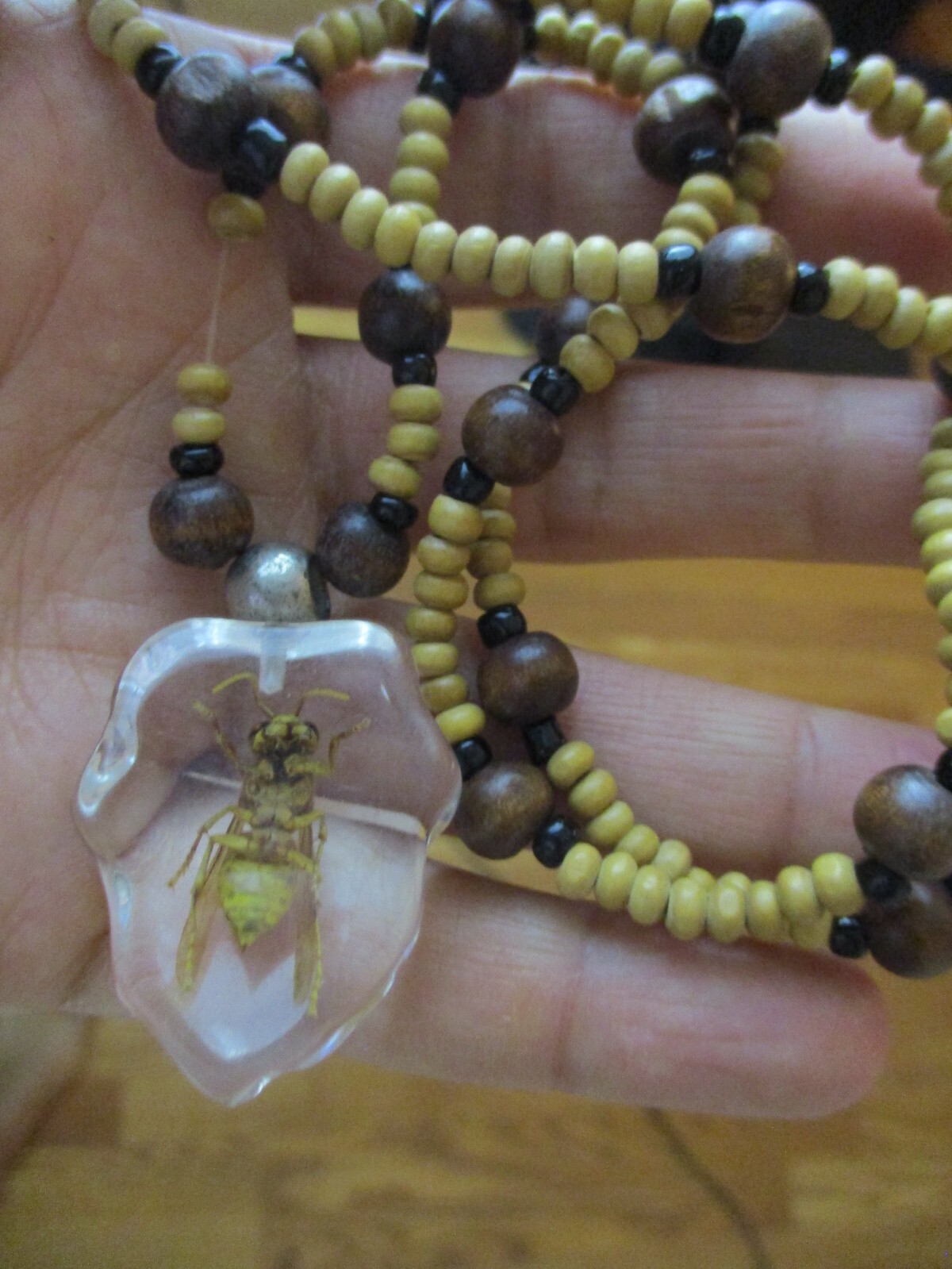 Necklace with bee coated plastic insect acrylic wood bead