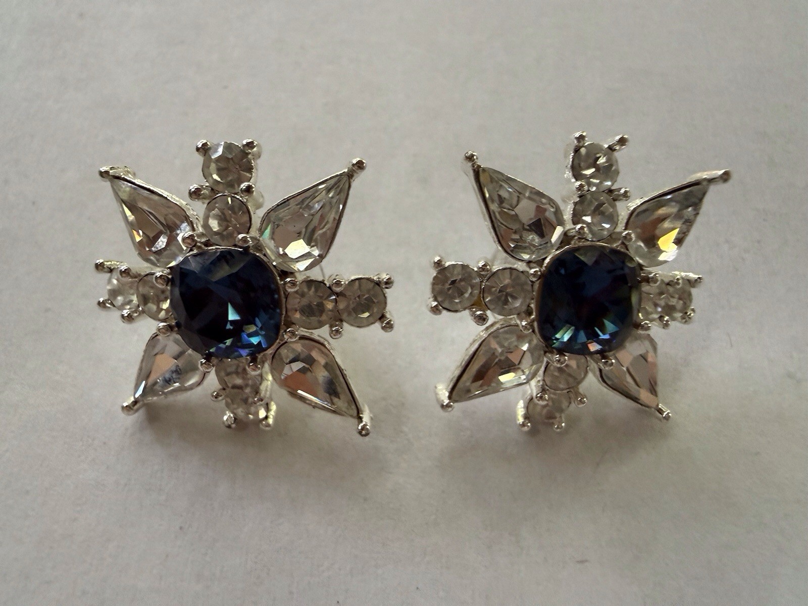 Napier pierced Silver Starburst Stud Earrings with Deep Blue Center .