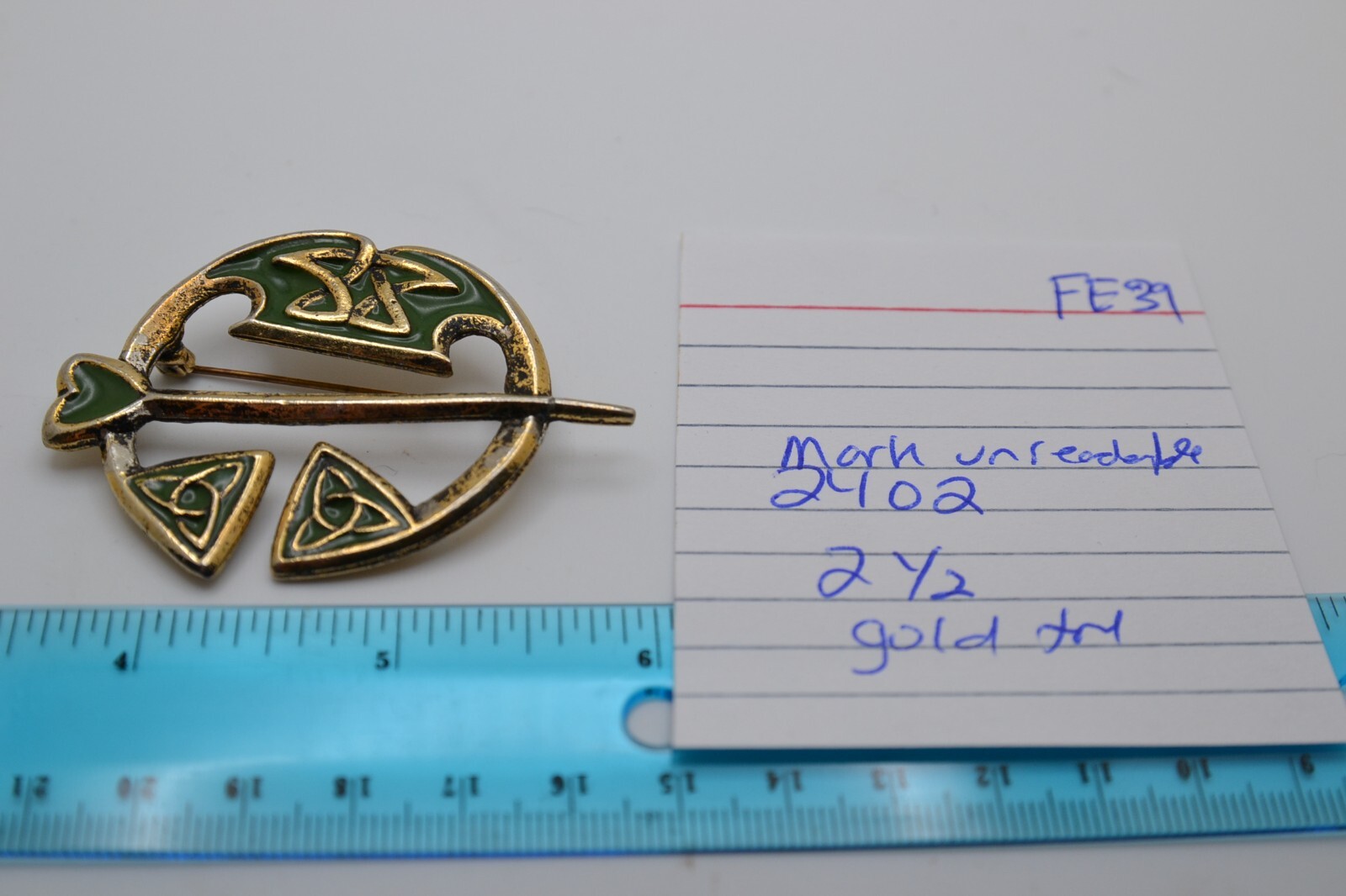 Green enamel & gold tone celtic brooch, mark unreadable FE39