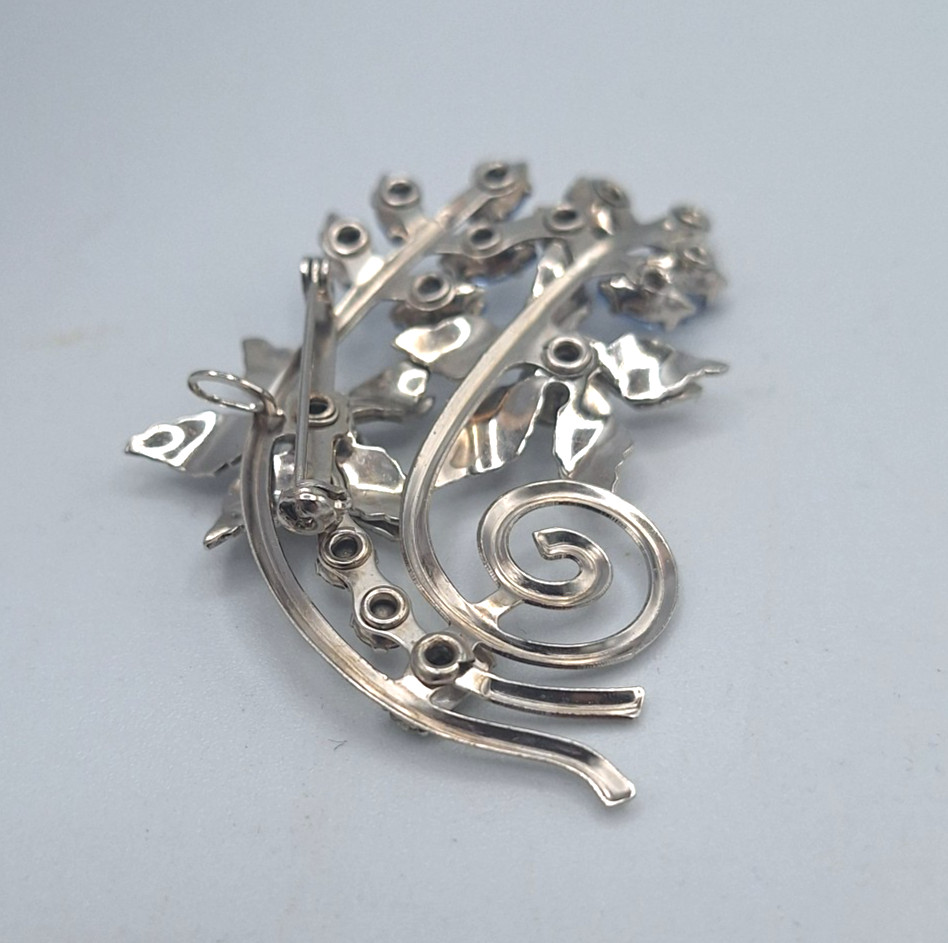 Unsigned Bugbee & Niles? Silver Tone Floral Spray Clear and Blue Flower Brooch
