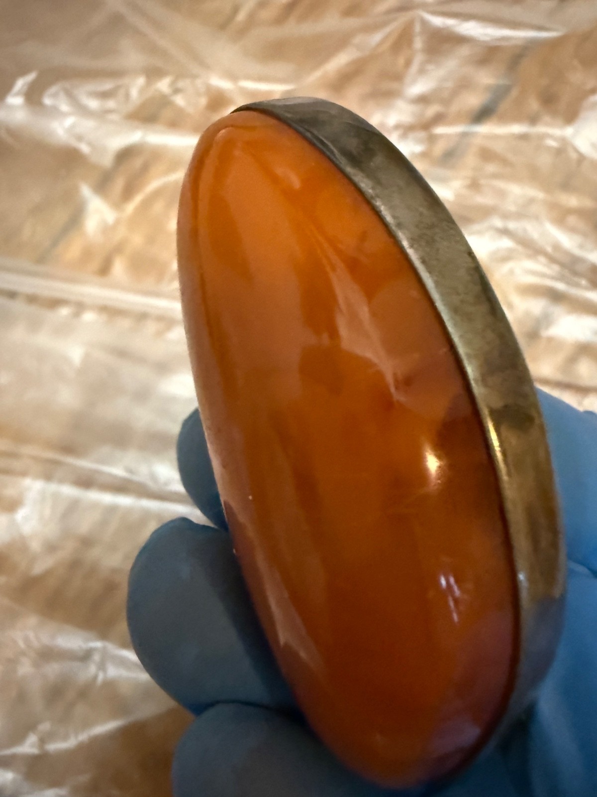 vintage sterling silver brooch features a large, warm-toned amber cabochon set
