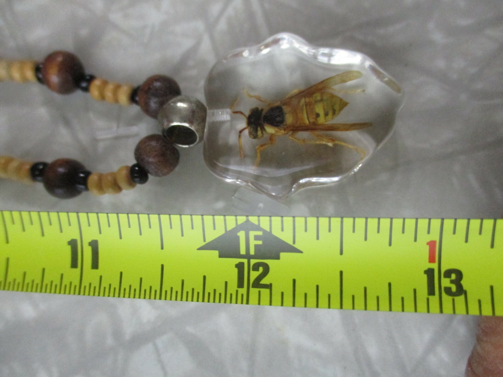 Necklace with bee coated plastic insect acrylic wood bead