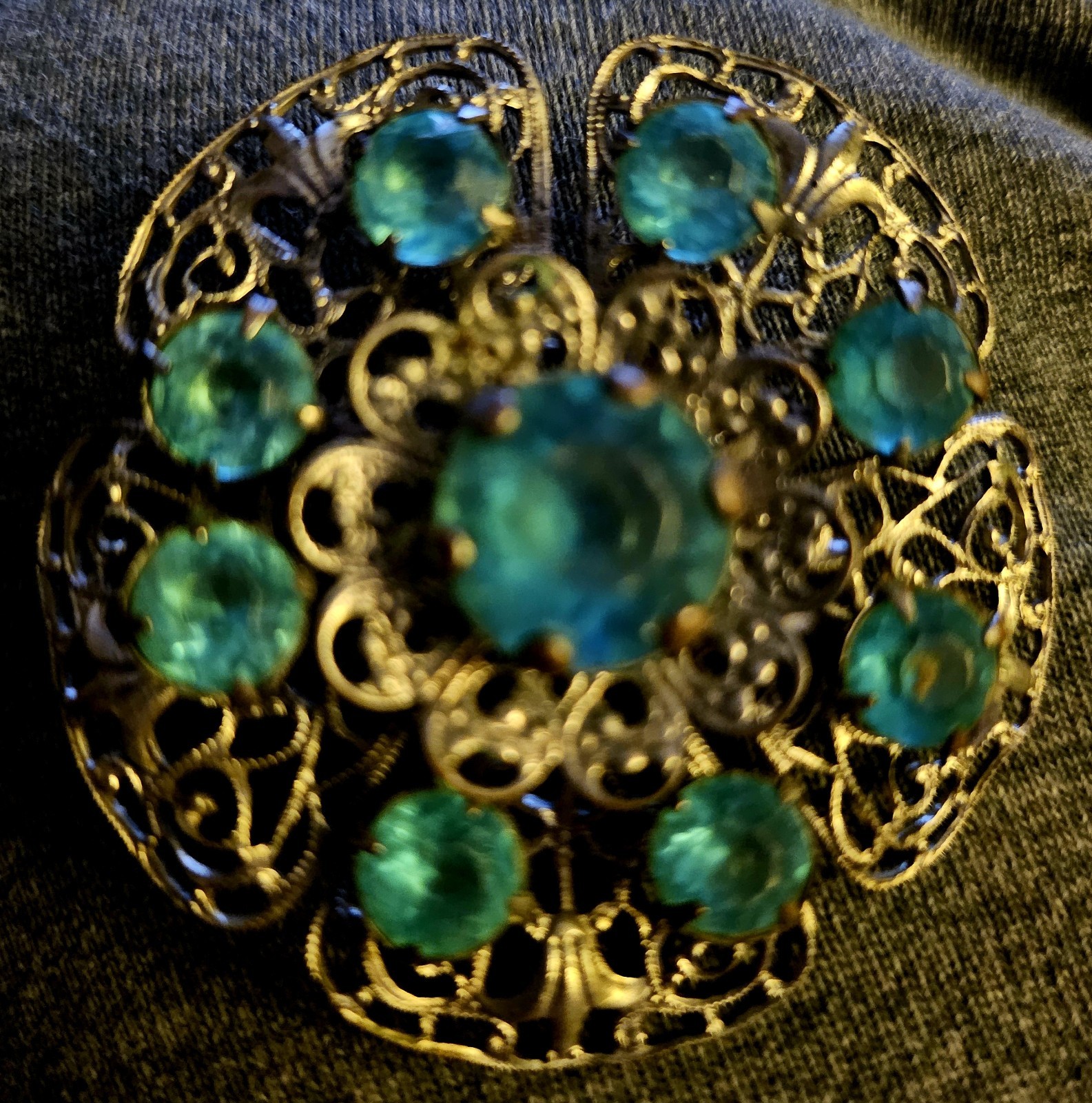 VTG Brooch featuring blue rhinestones set in a silver-tone filigree metal.