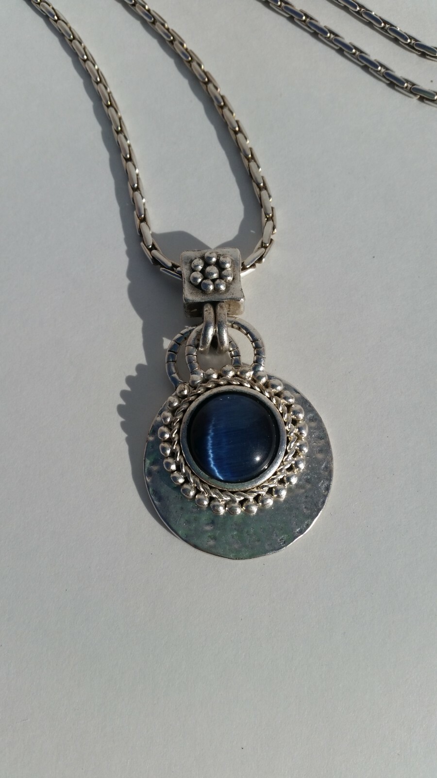 Blue Tiger Eye Cabochon style pendant with a convex formed silver toned reverse