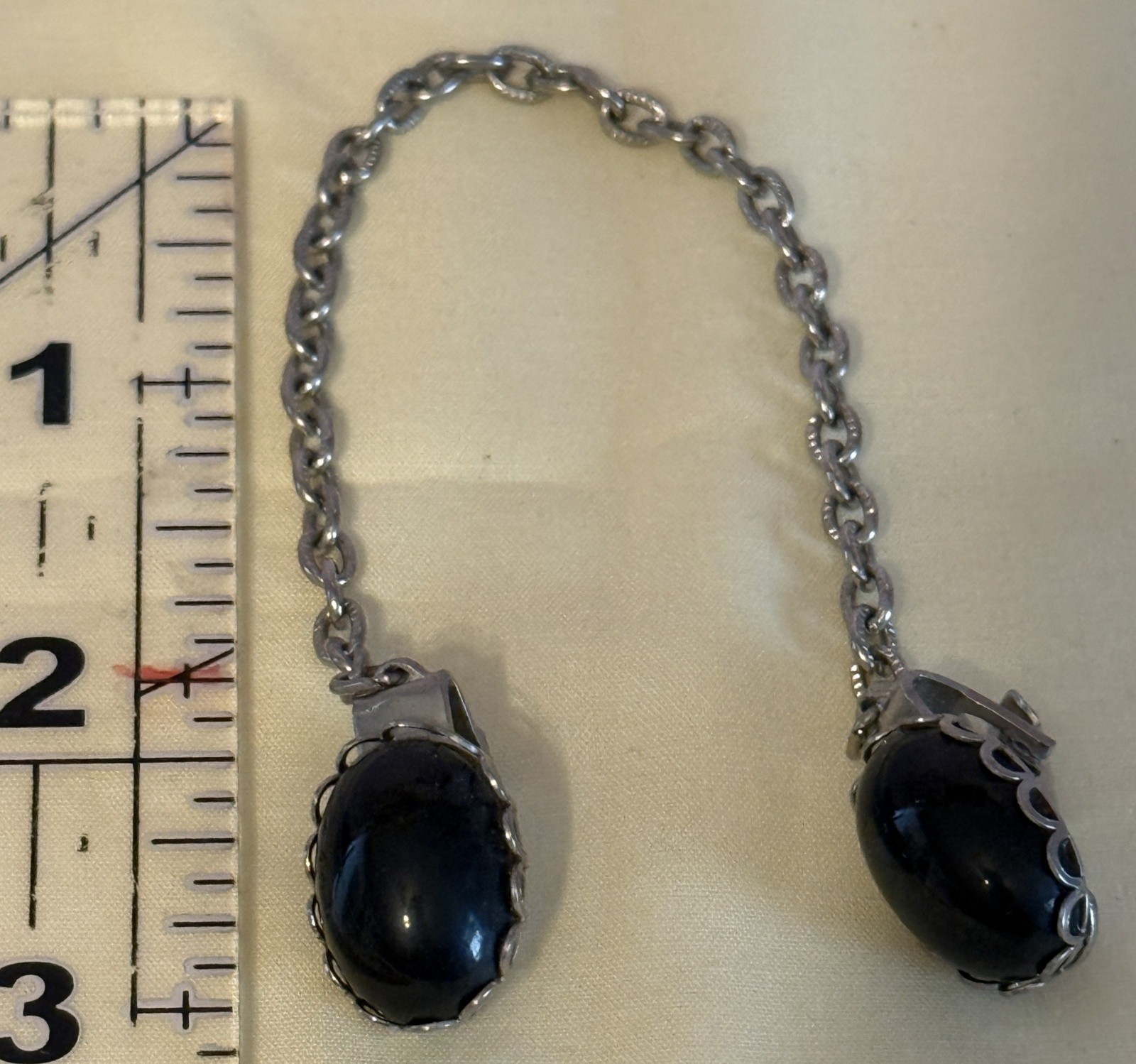 Vintage Silver Tone Cardigan Clip featuring two black oval stones