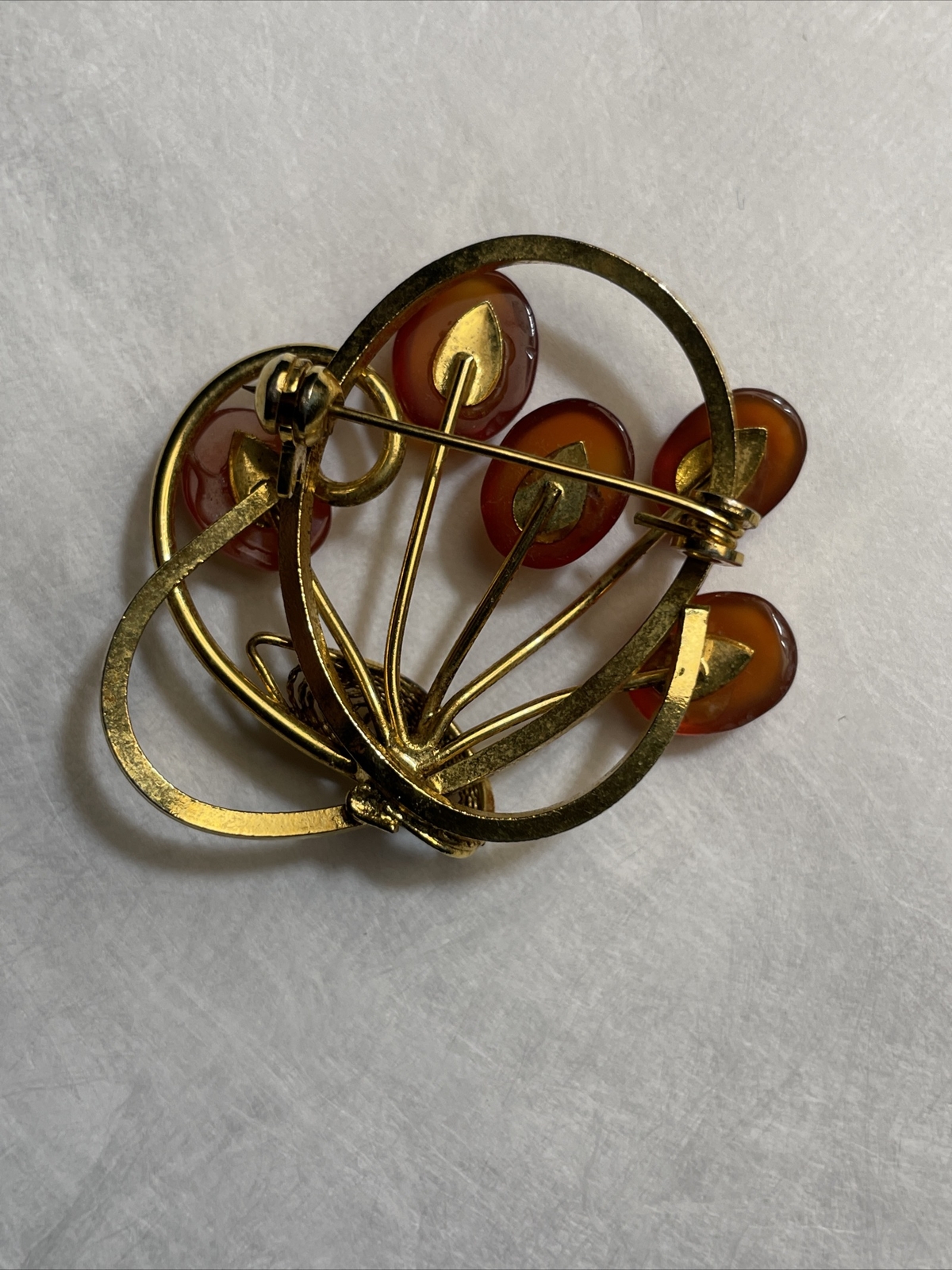 Vintage gold tone brooch with amber colored stones