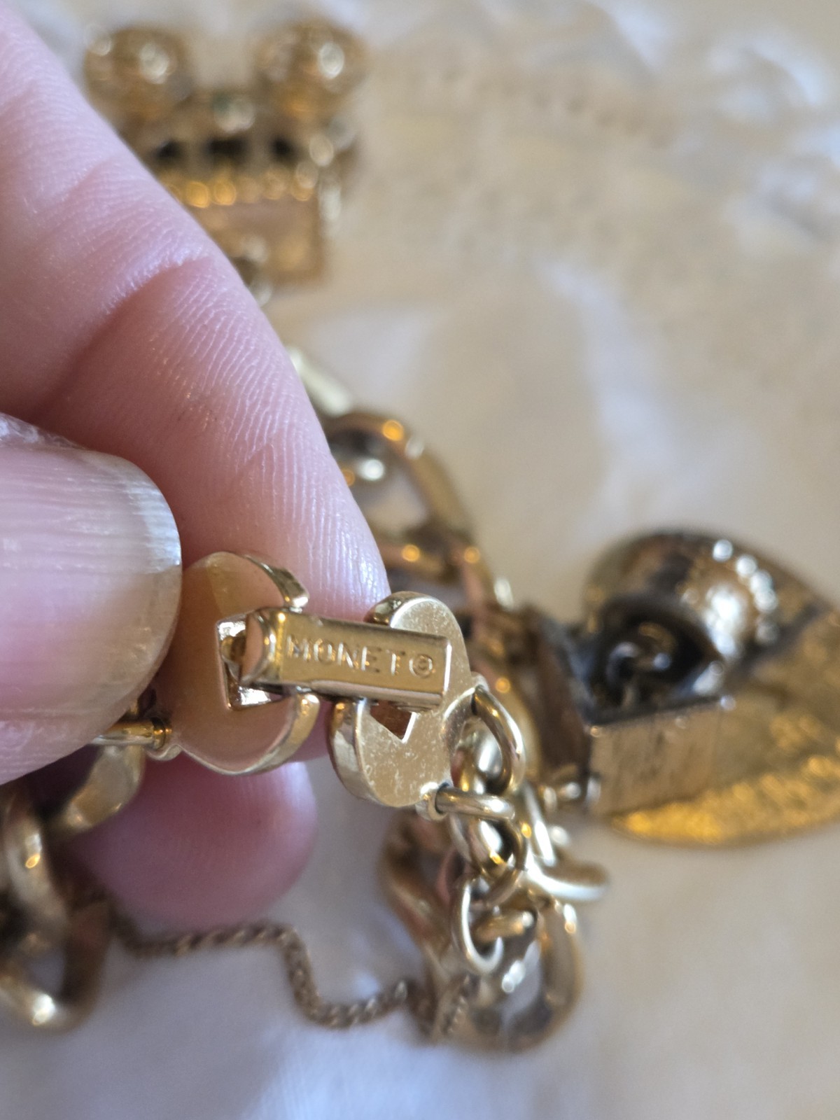 vintage Monet gold-tone charm bracelet features multiple detailed charms