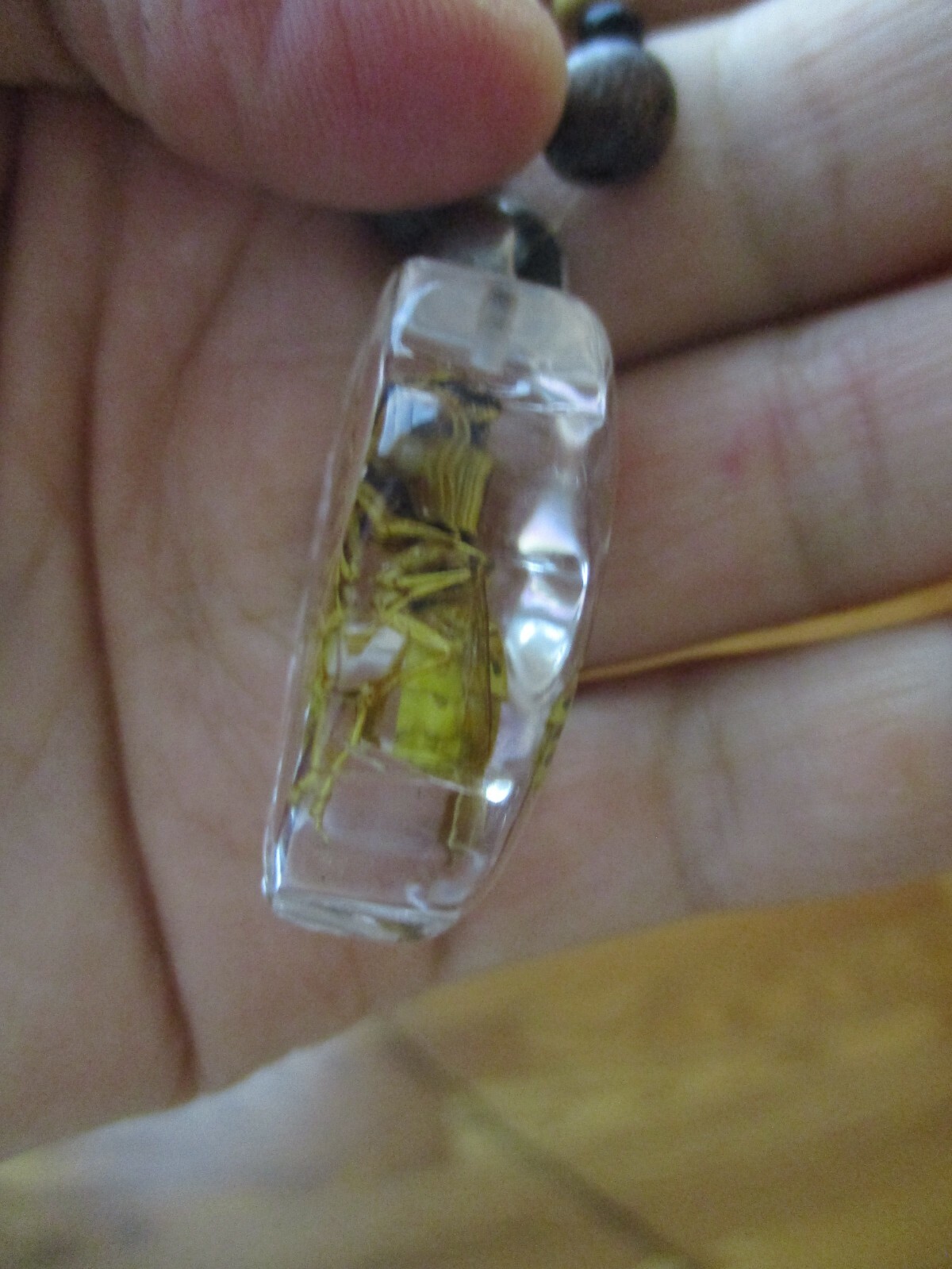 Necklace with bee coated plastic insect acrylic wood bead