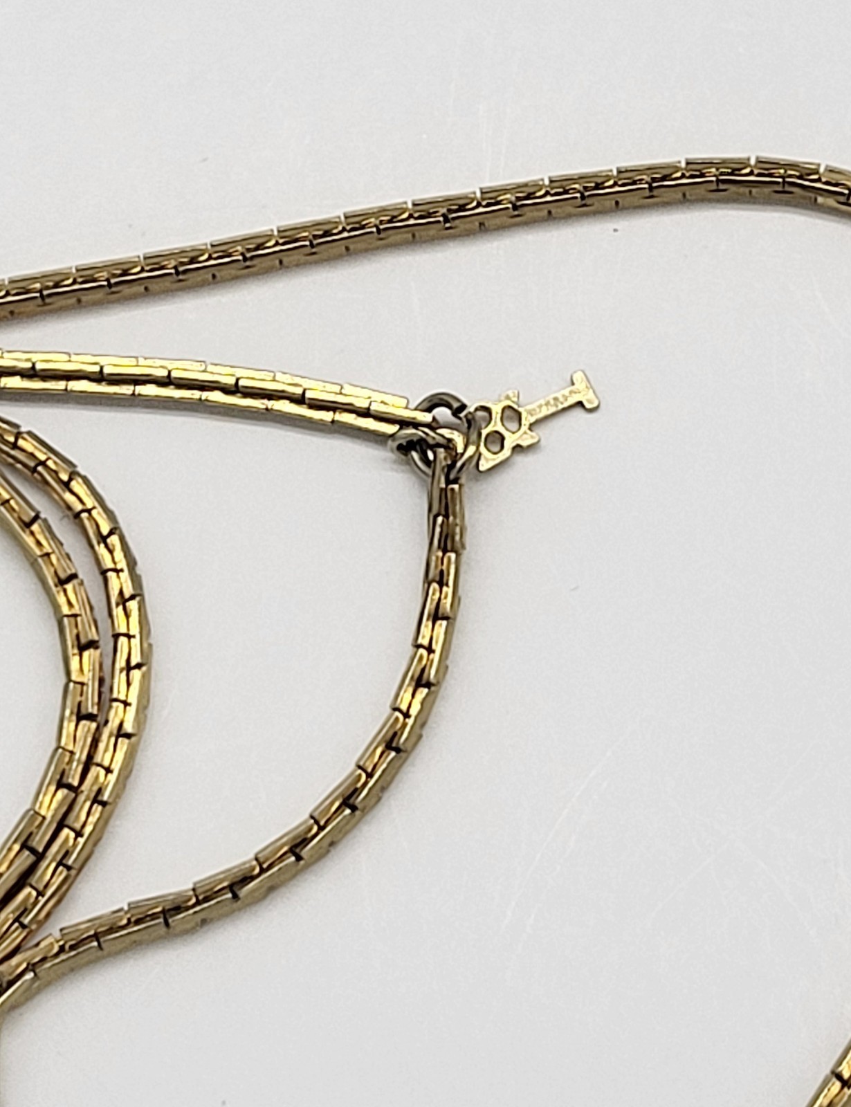 Vintage Trifari 54″ gold tone metal necklace, no clasp, Thin, sleek