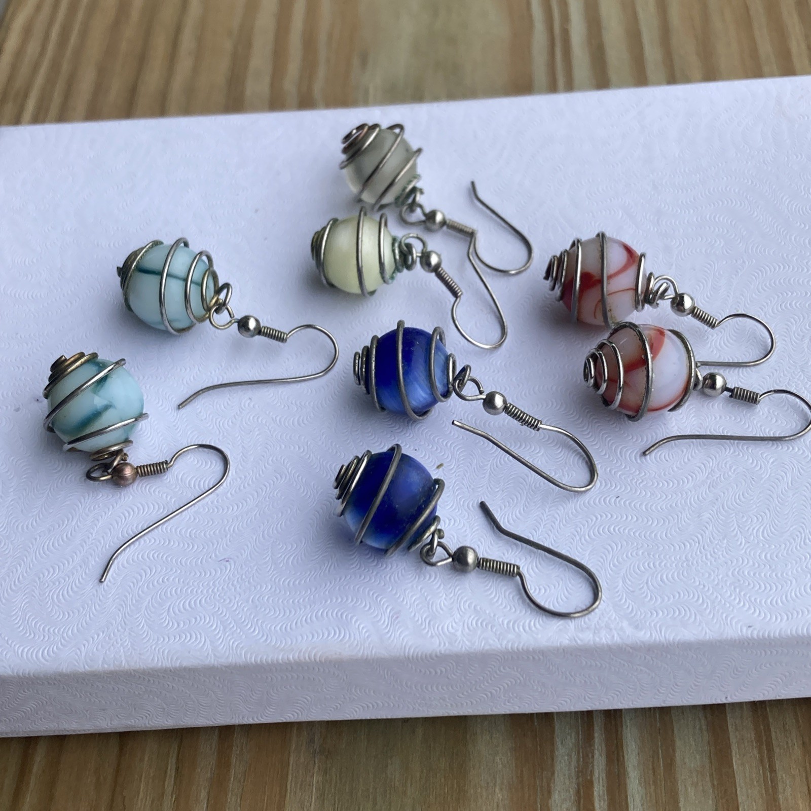 4 pr. vintage wire wrapped cased glass marble dangle, / pierced earrings