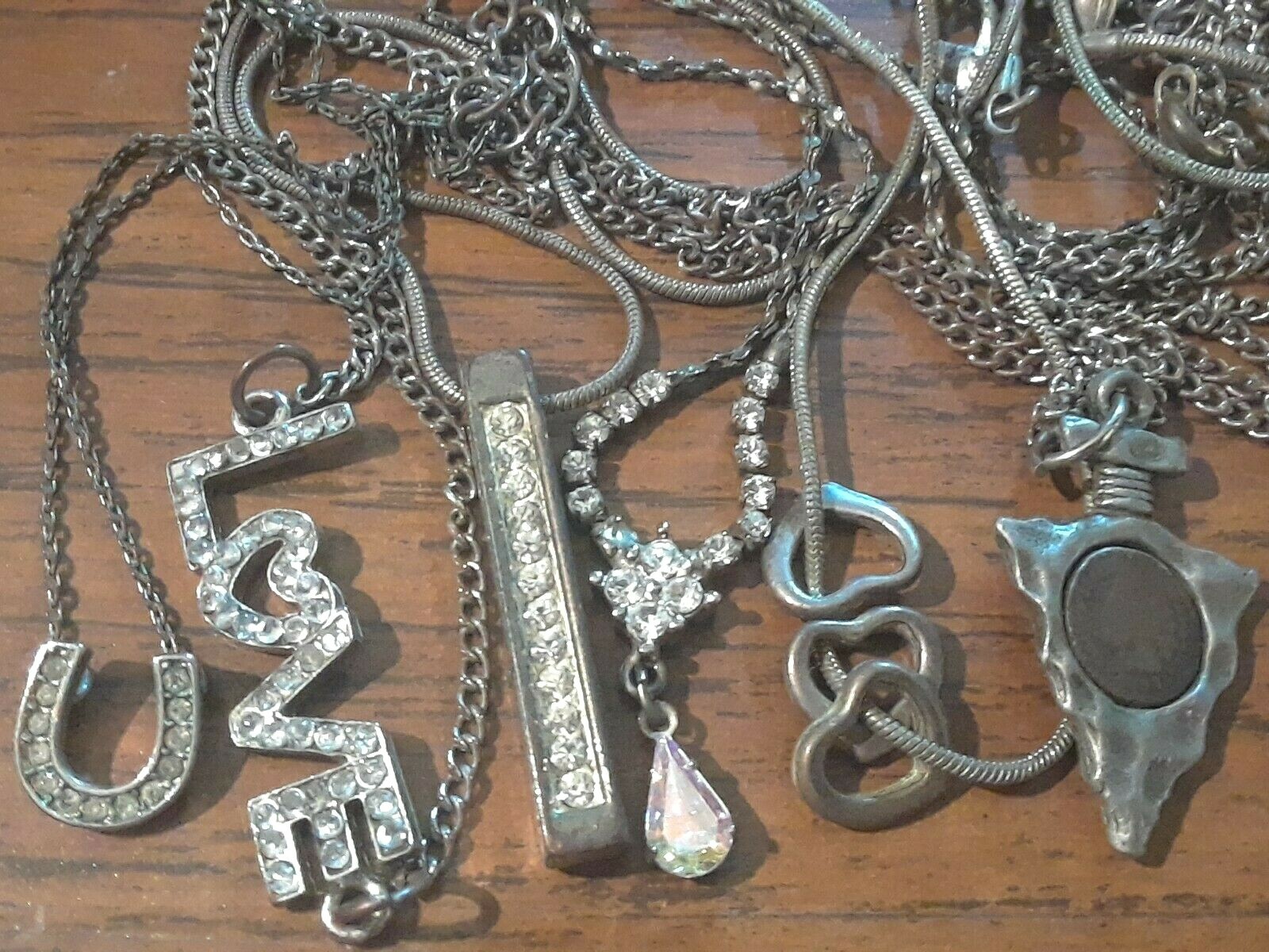 Lot of silver tone chain necklaces with rhinestone pendants. Coin, Love + Luck