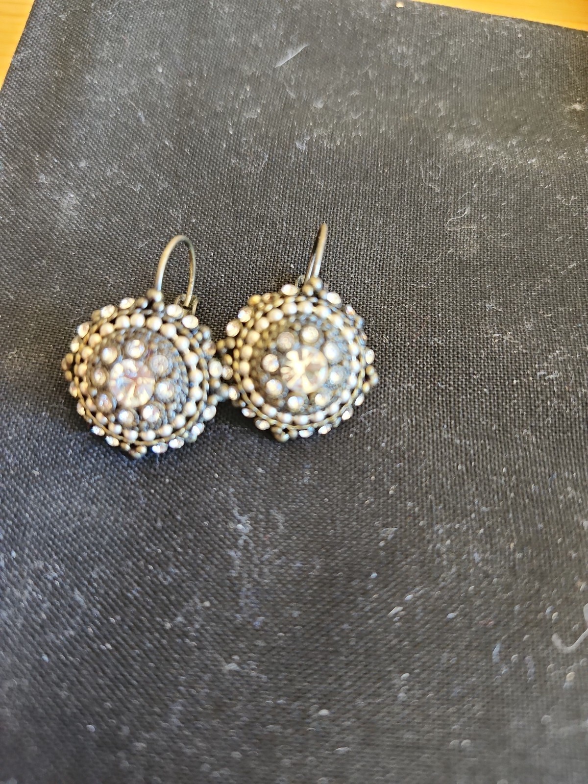 Vintage style costume jewelry earrings featuring a circular halo cluster design