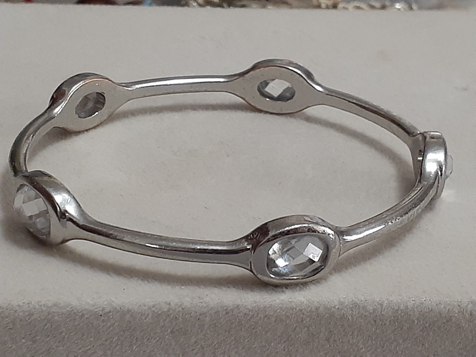 Fauceted crystal accent bangle bracelet Silvertone bezel set stones