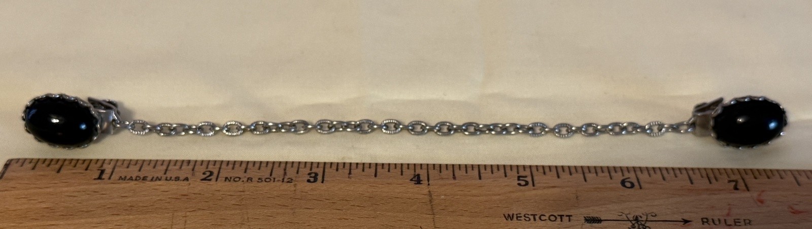 Vintage Silver Tone Cardigan Clip featuring two black oval stones
