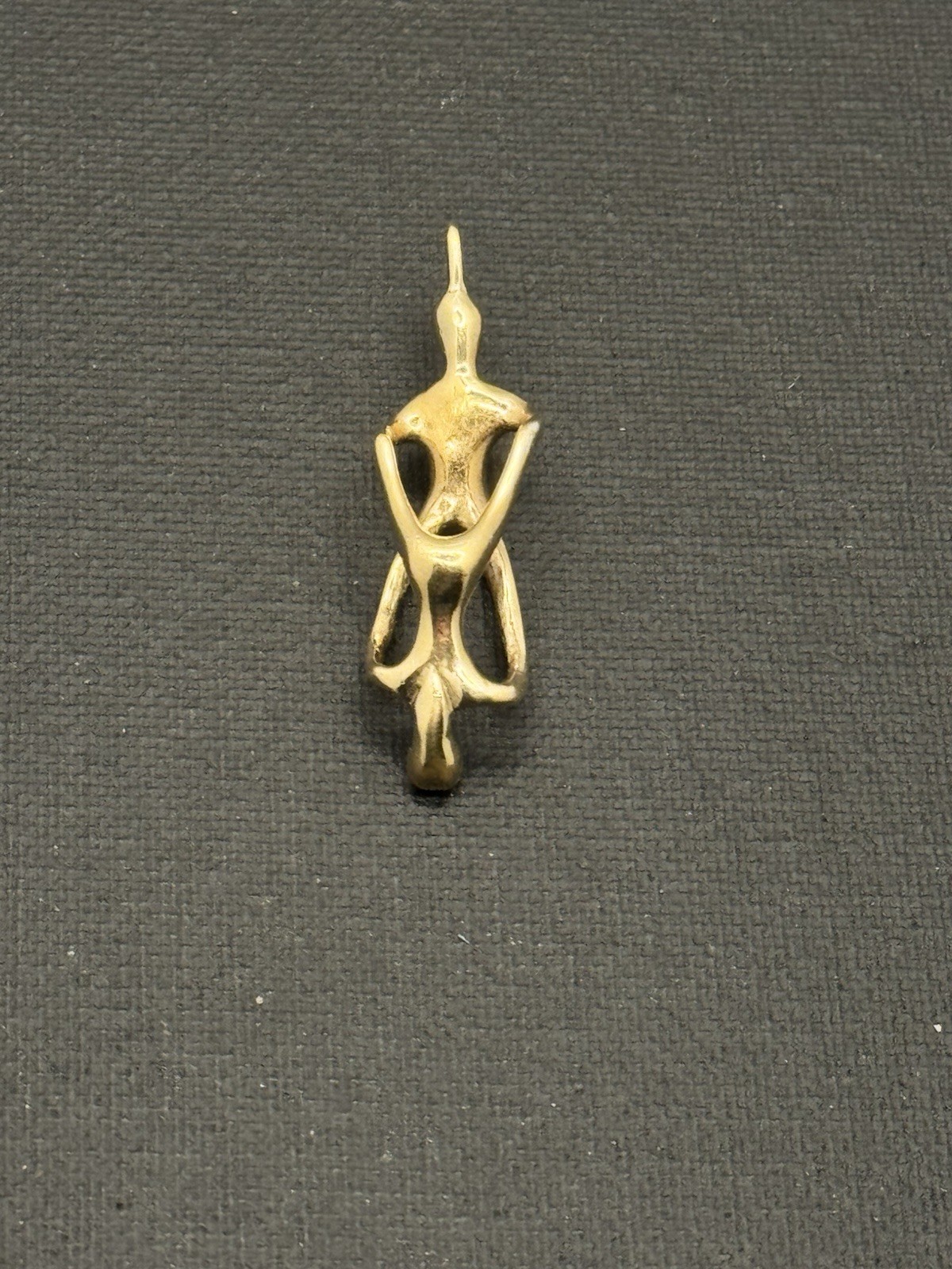 Vintage-style abstract woman figure pendant. Gold-tone metal