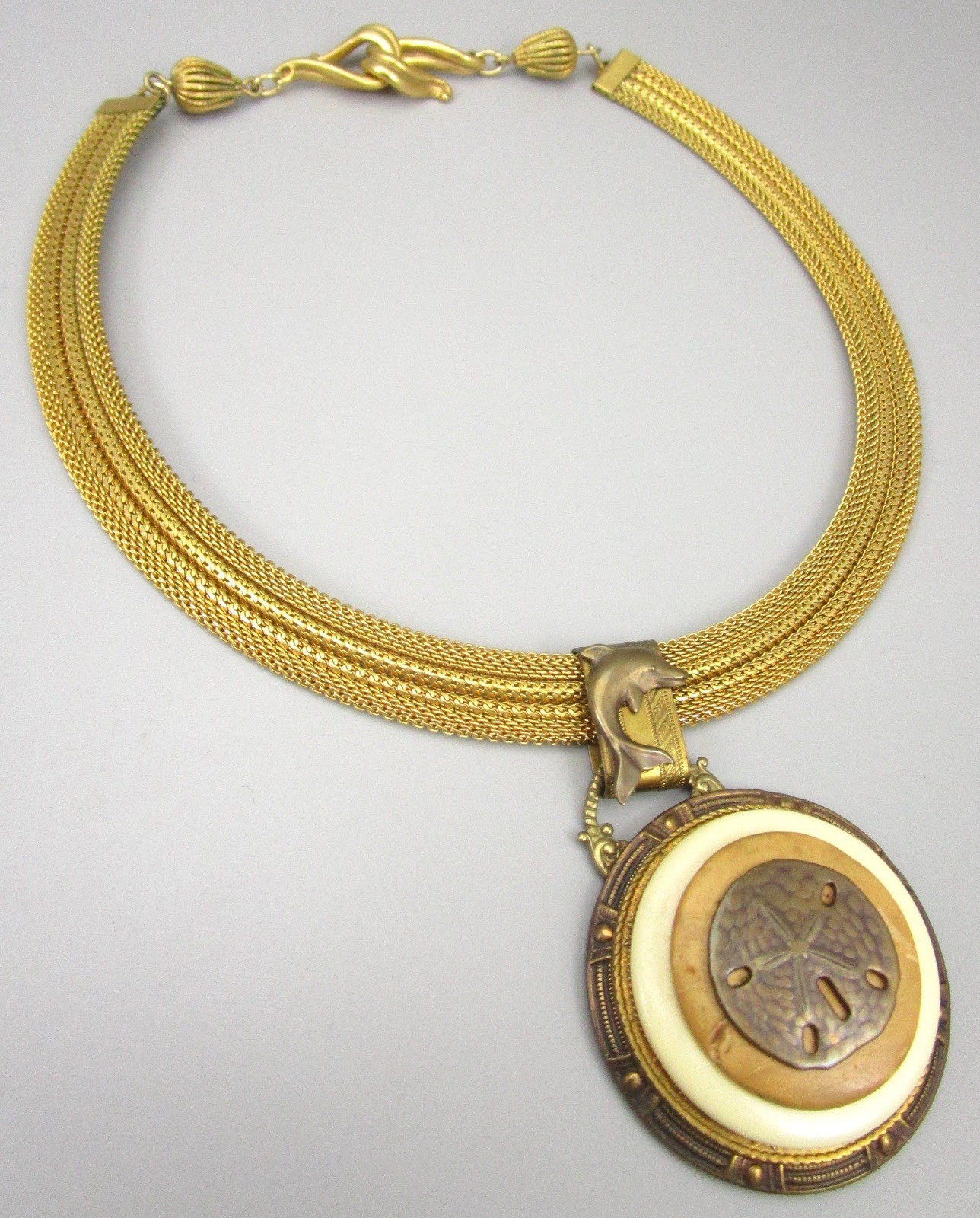 LOVELY PATRICE BRASS RESIN &  SHELL SAND DOLLAR DOLPHIN STATEMENT NECKLAC