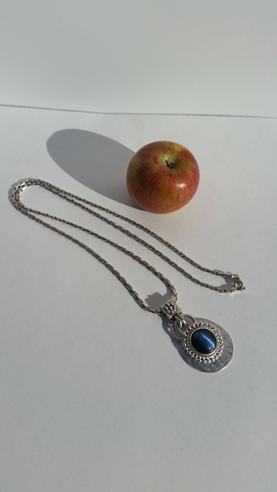 Blue Tiger Eye Cabochon style pendant with a convex formed silver toned reverse