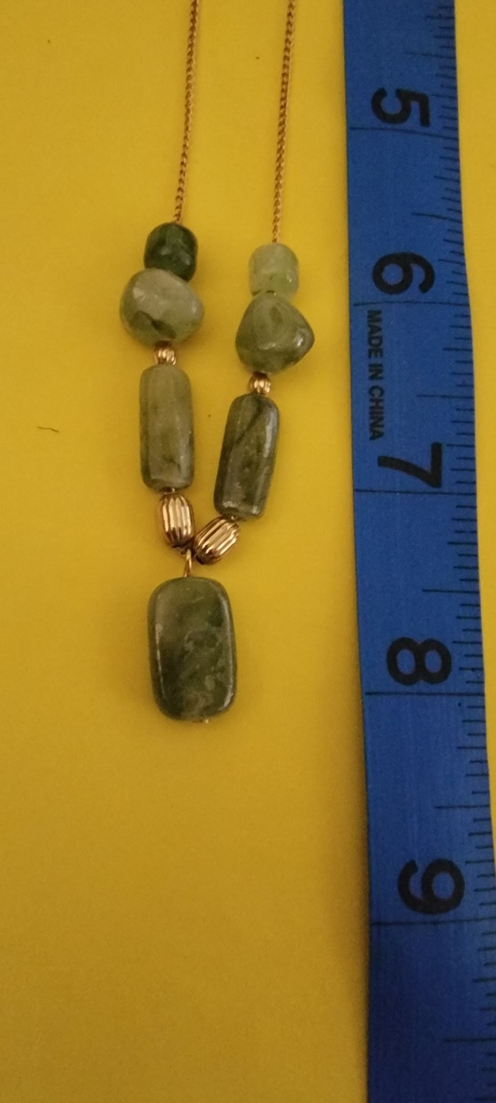 Vintage Act II necklace featuring polished green stones and a delicate gold-tone