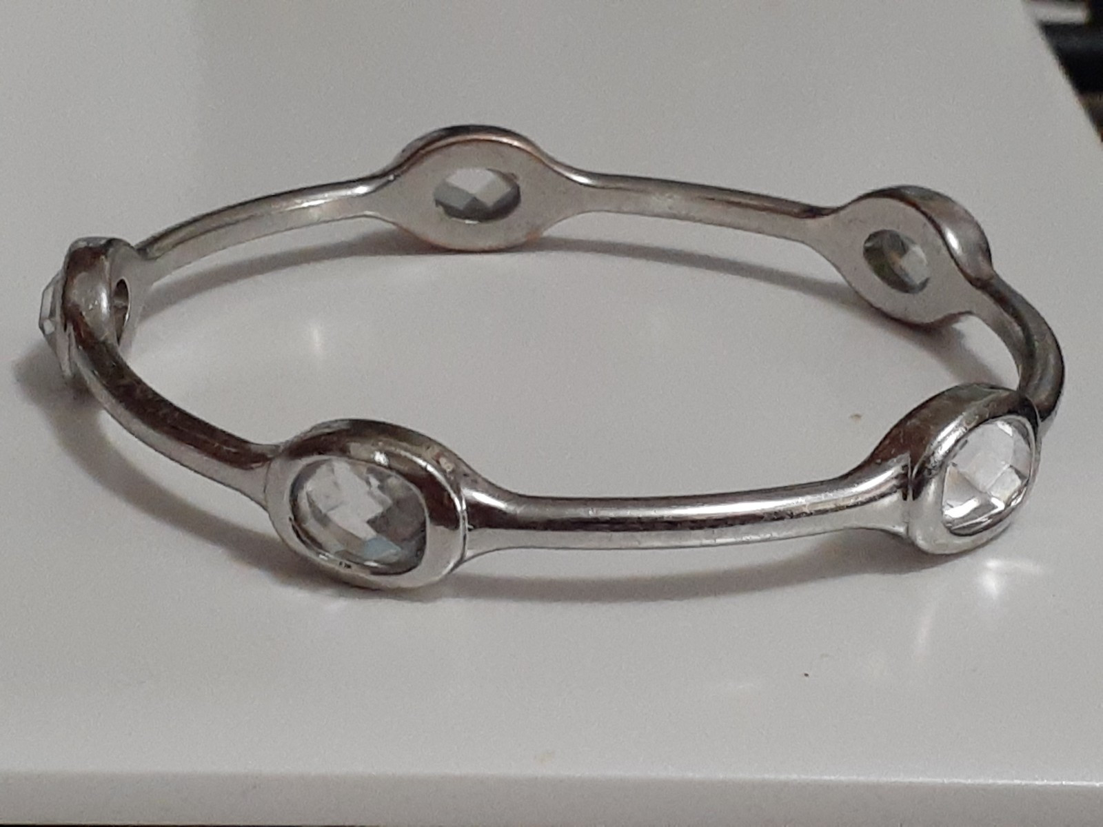 Fauceted crystal accent bangle bracelet Silvertone bezel set stones