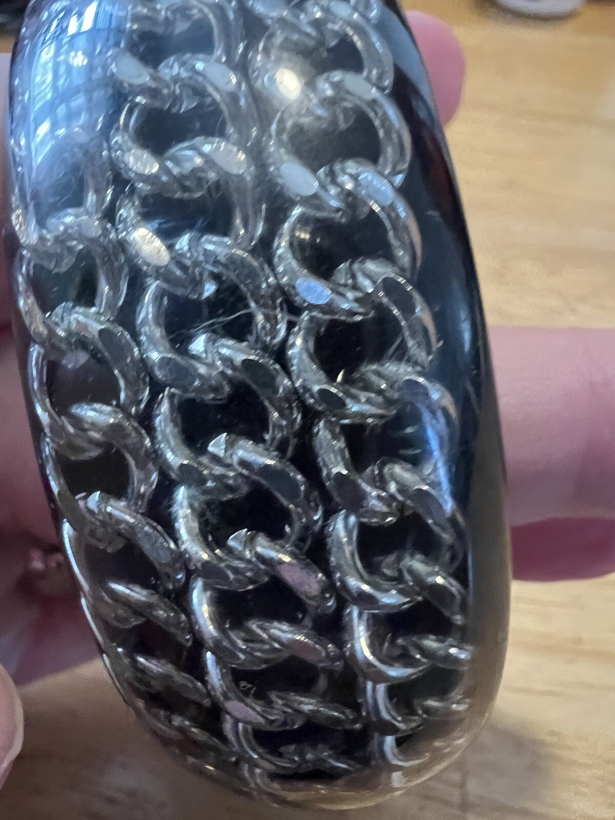 BLACK ACRYLIC LUCITE BANGLE WITH ENCASED SILVERTONE CHAINS
