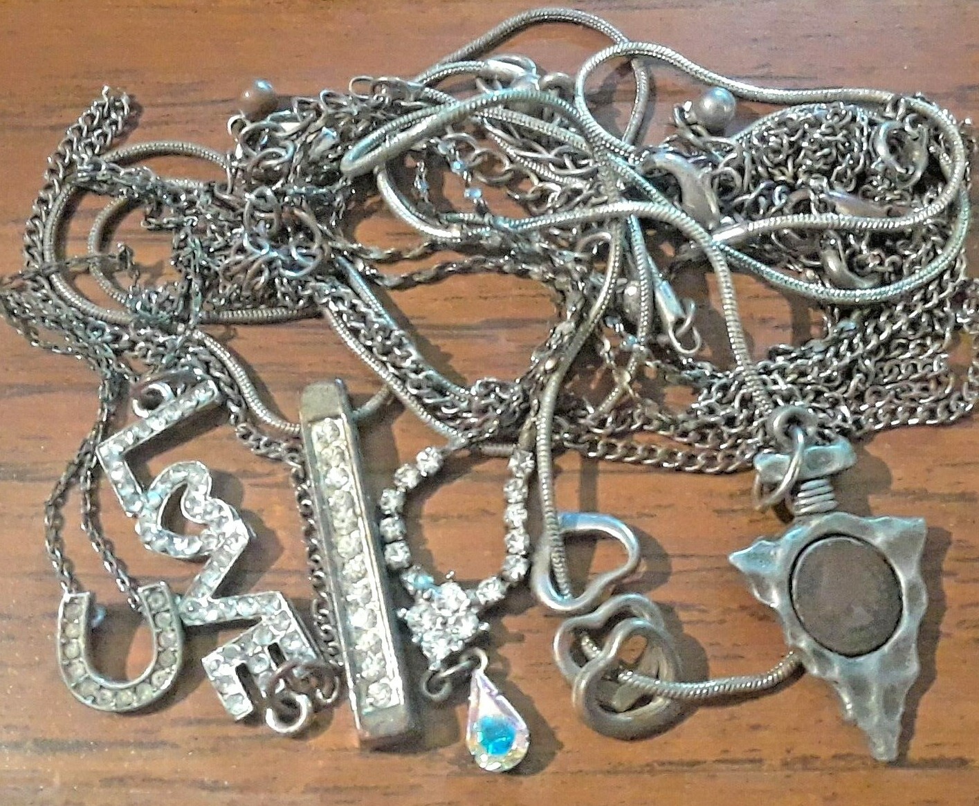 Lot of silver tone chain necklaces with rhinestone pendants. Coin, Love + Luck