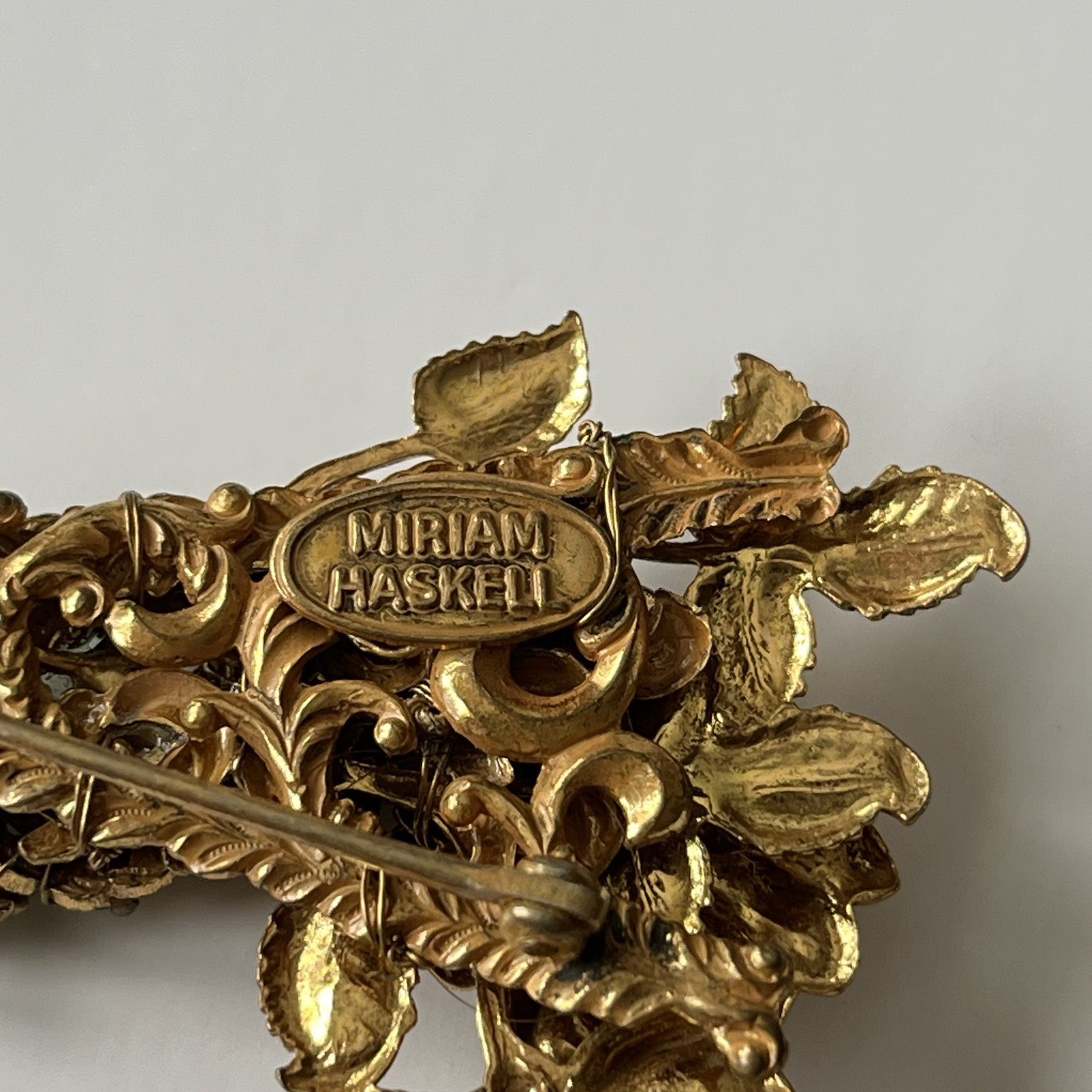 VTG Miriam Haskell Bar Brooch Green Rhinestone Floral Filigree Goldstone Signed