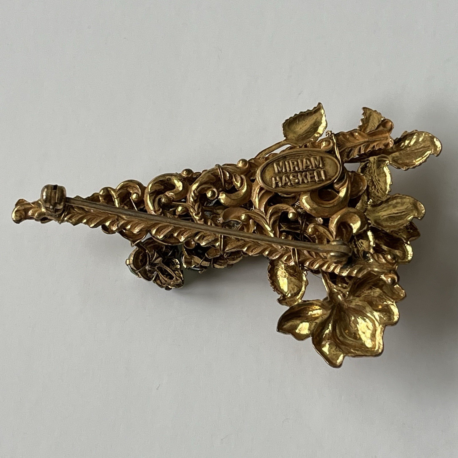 VTG Miriam Haskell Bar Brooch Green Rhinestone Floral Filigree Goldstone Signed
