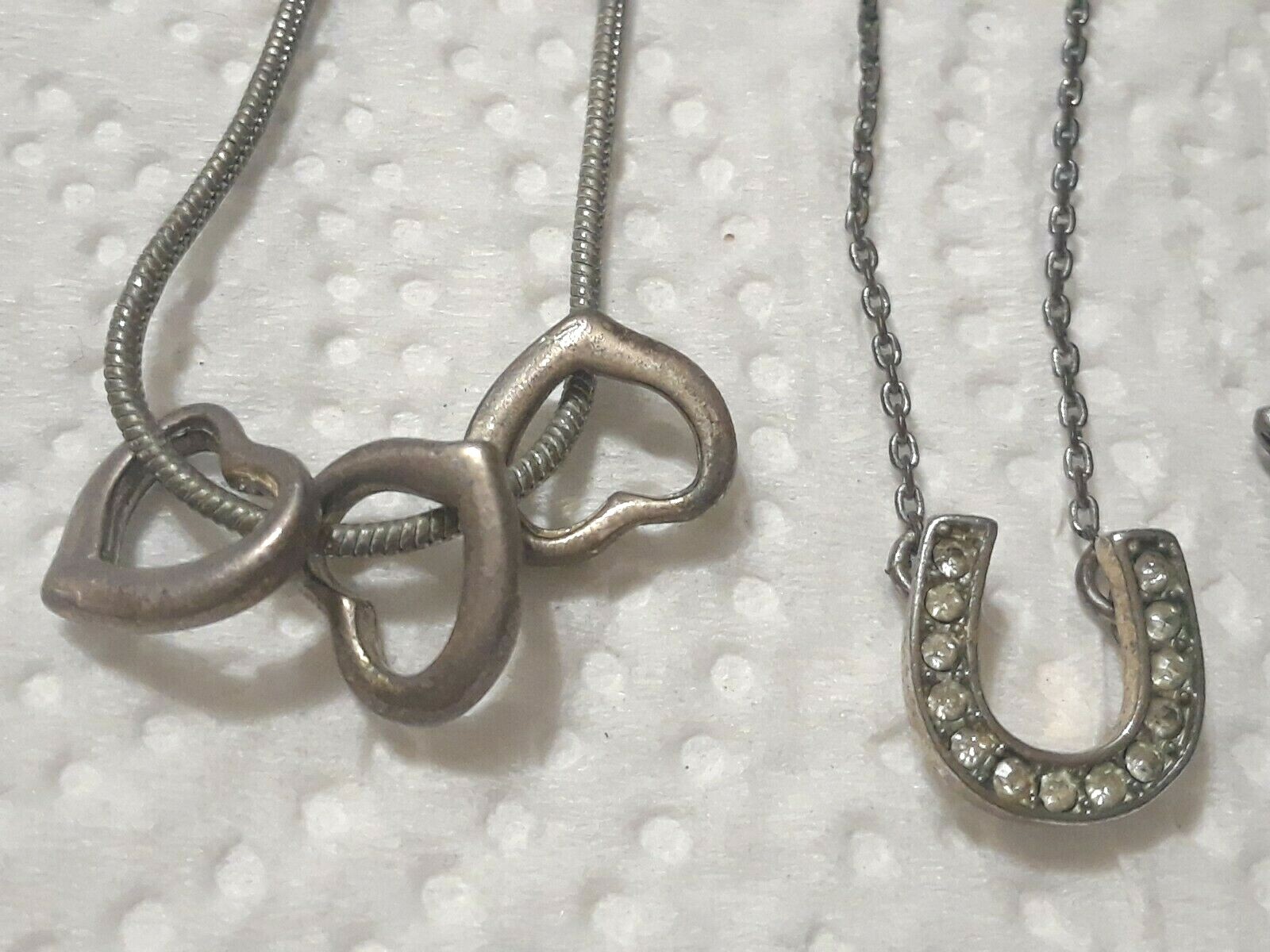 Lot of silver tone chain necklaces with rhinestone pendants. Coin, Love + Luck