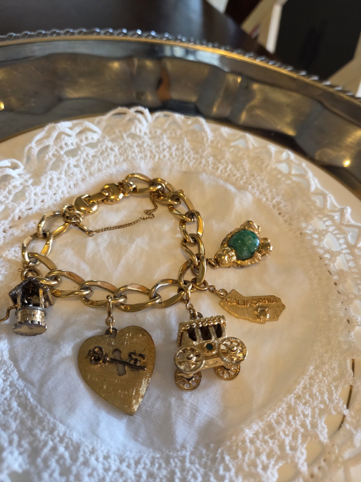 vintage Monet gold-tone charm bracelet features multiple detailed charms