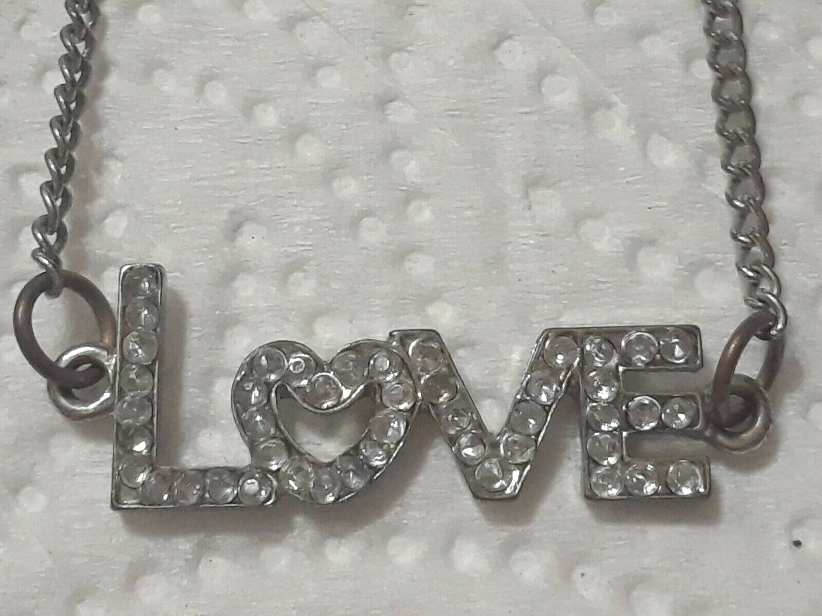 Lot of silver tone chain necklaces with rhinestone pendants. Coin, Love + Luck
