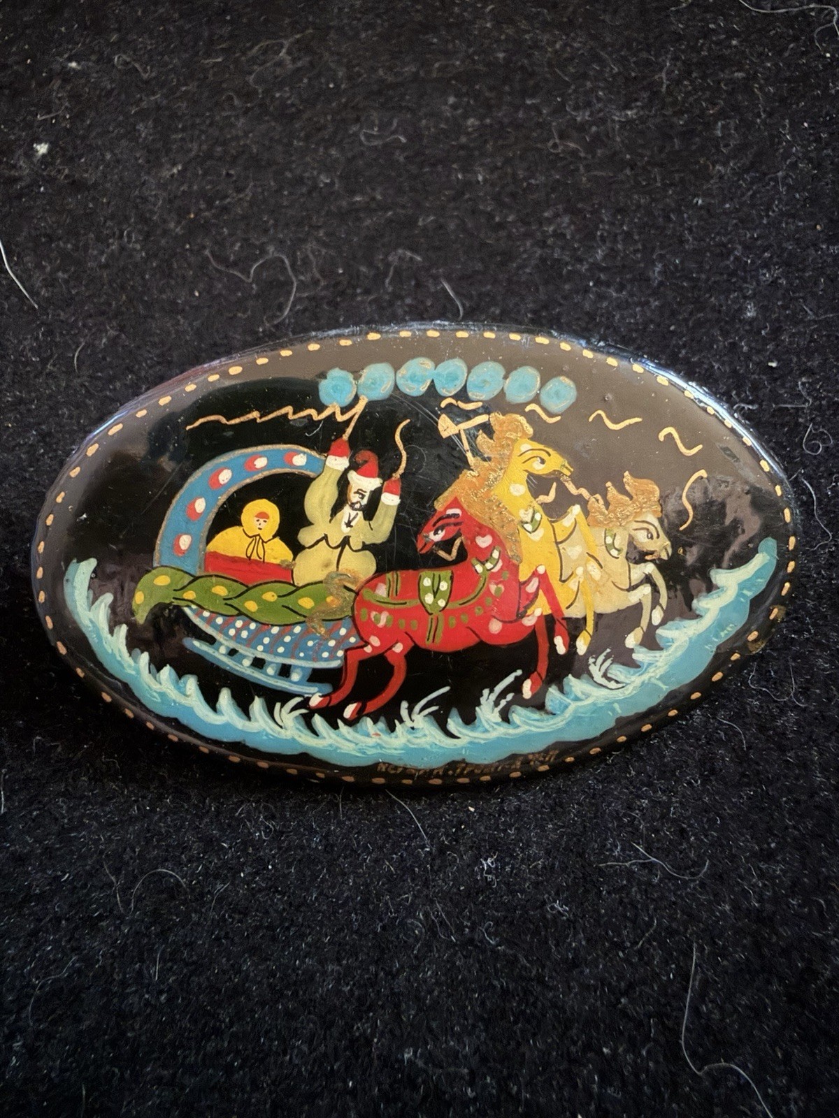 Russian hand-painted lacquer brooch featuring a traditional troika scene