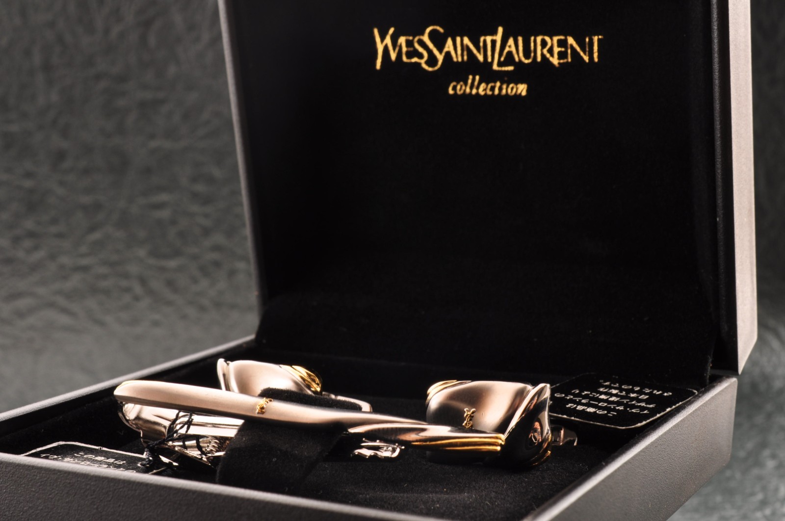 Near mint, gold and Cufflinks and silver tie clip, “Yves Saint Laurent”, case.