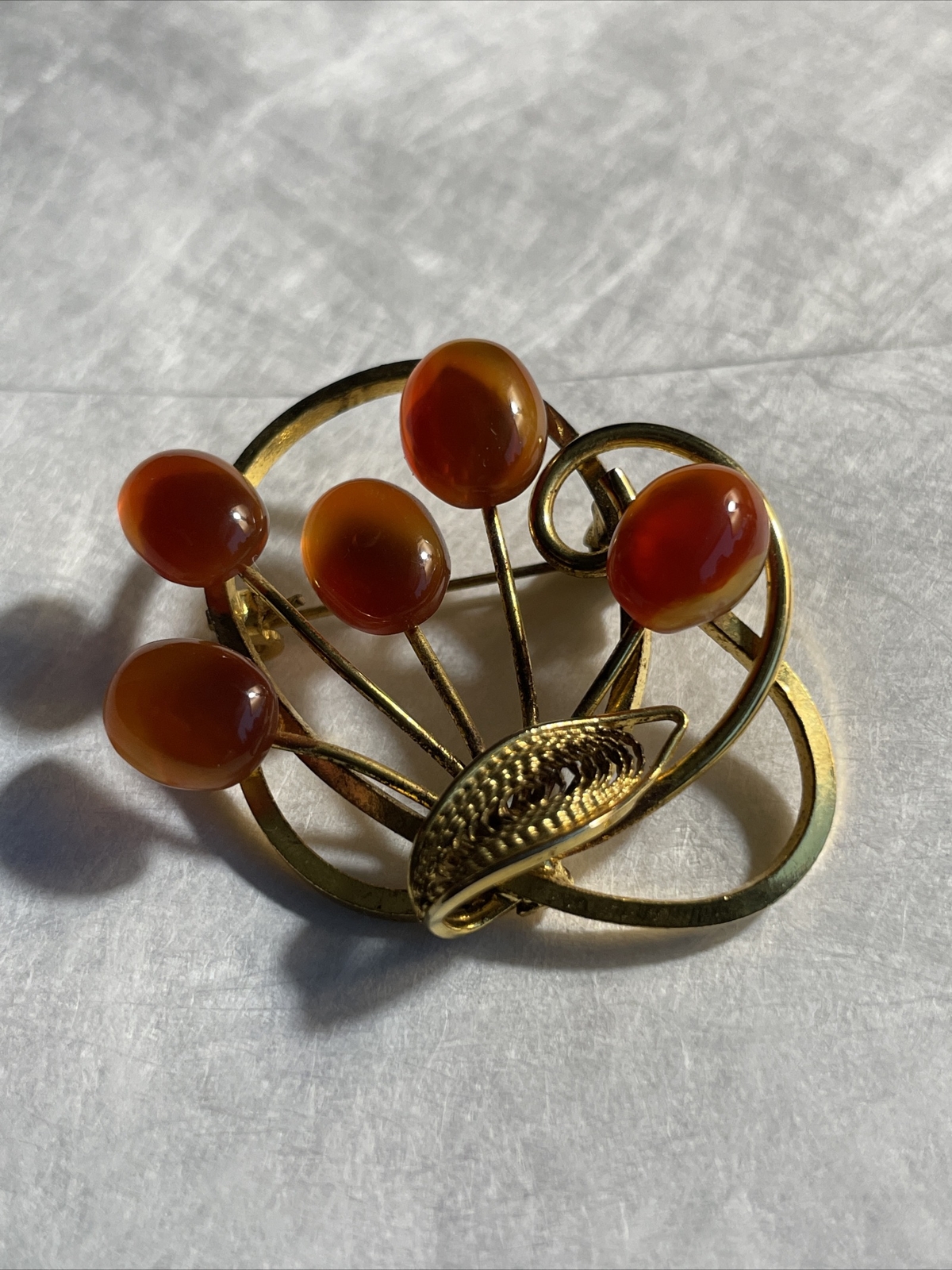 Vintage gold tone brooch with amber colored stones