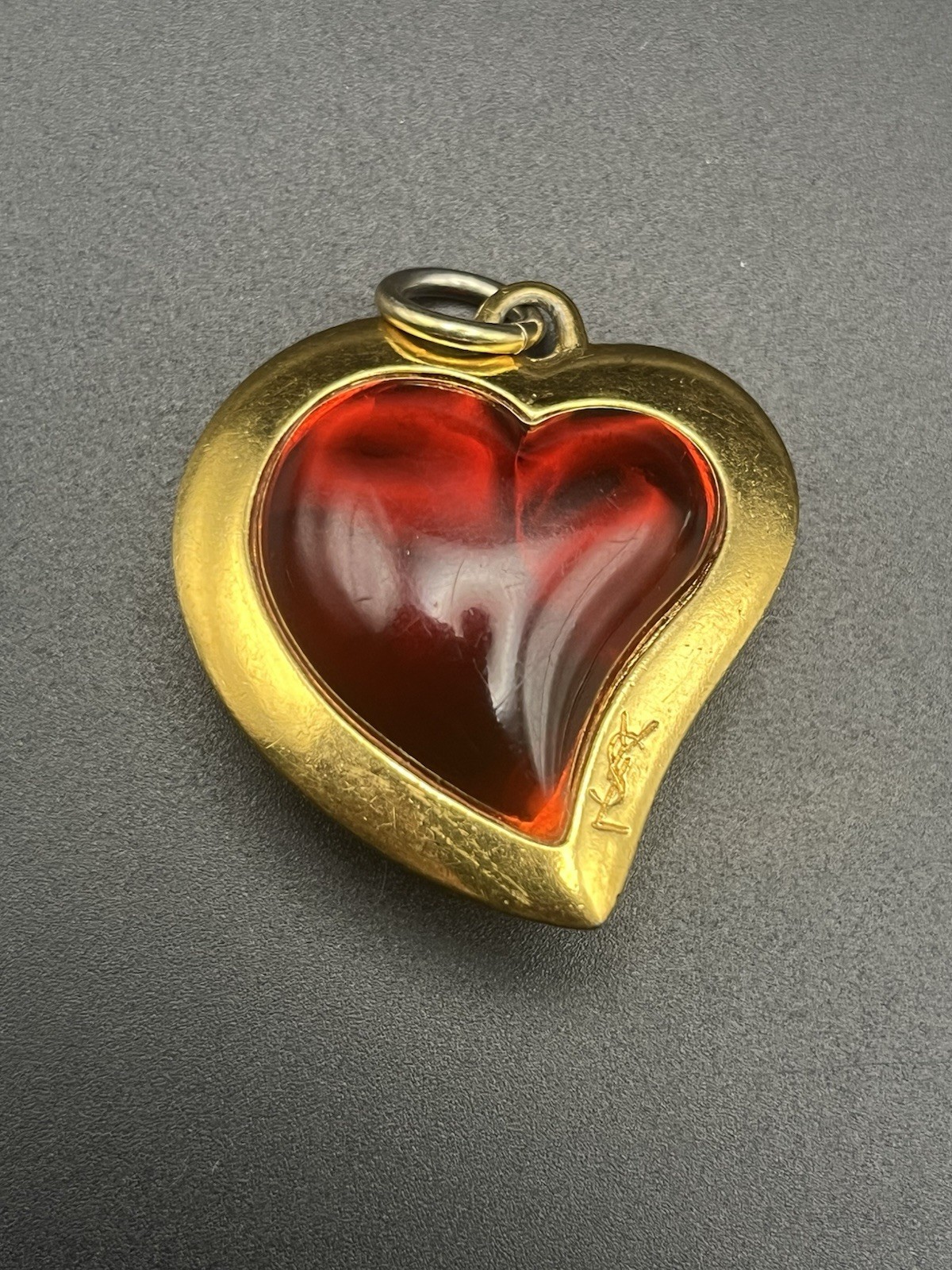 VTG 80’s Yves Saint Laurent (YSL) gold-tone metal and red resin heart pendant.