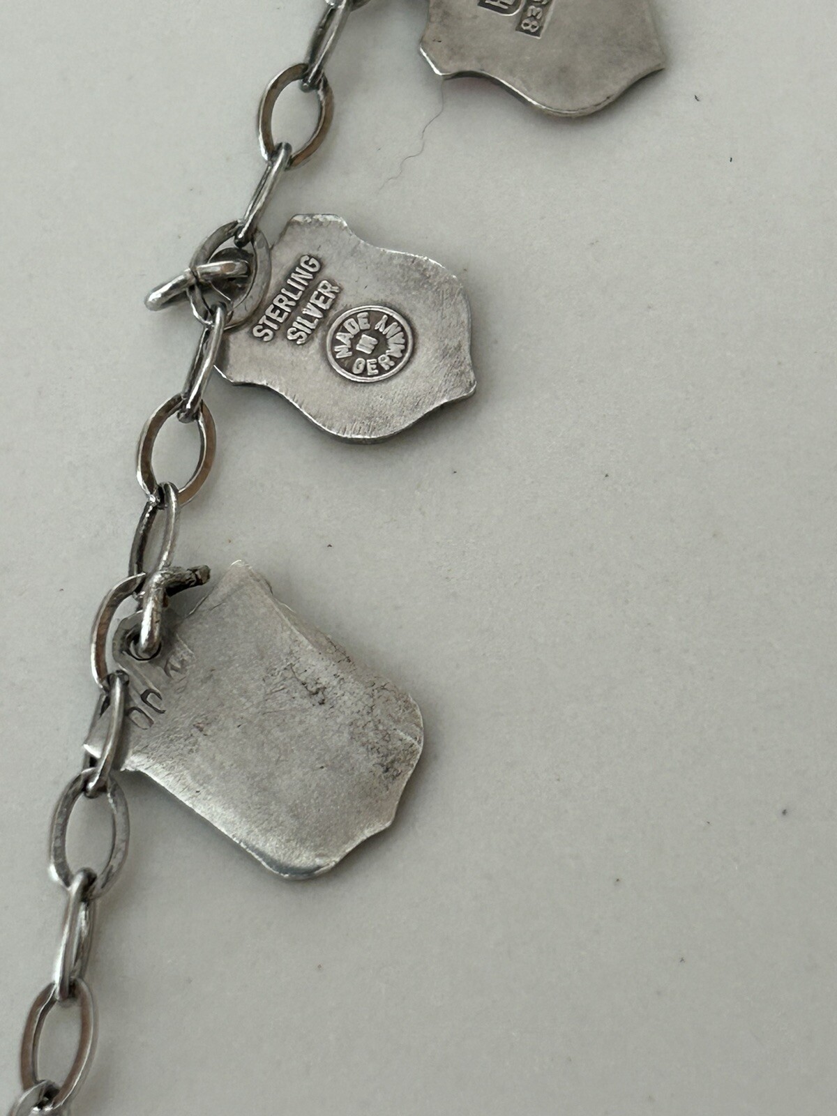 VINTAGE SOLID SILVER AND ENAMEL TRAVEL CHARM BRACELET6 COAT OF ARMS (8 TOTAL)