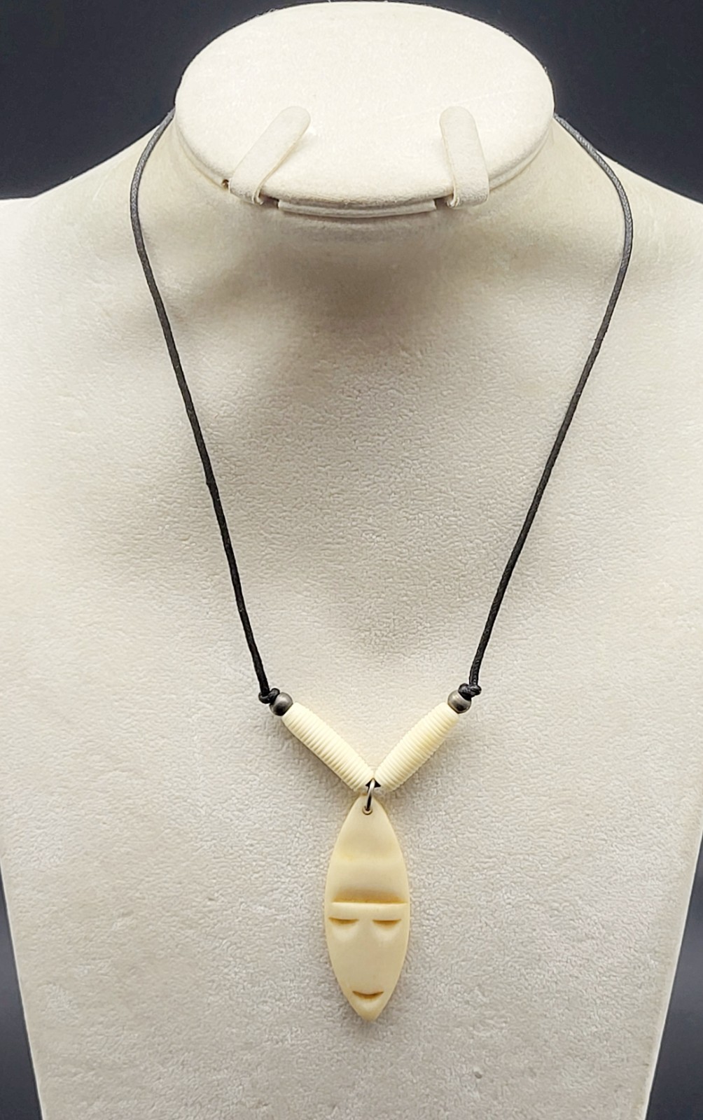 Vintage 18″ vinyl necklace with shield shape bone face pendant