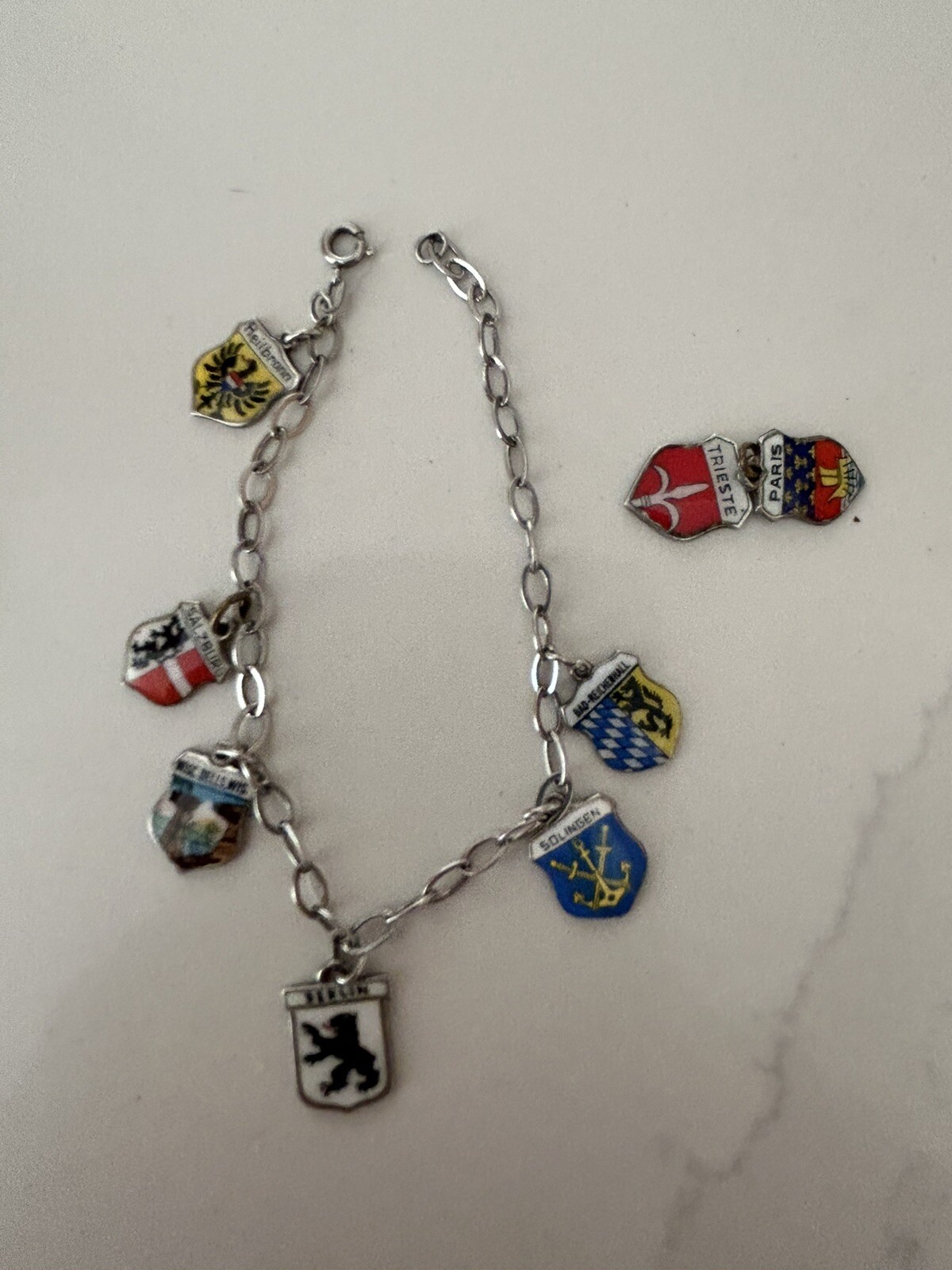VINTAGE SOLID SILVER AND ENAMEL TRAVEL CHARM BRACELET6 COAT OF ARMS (8 TOTAL)