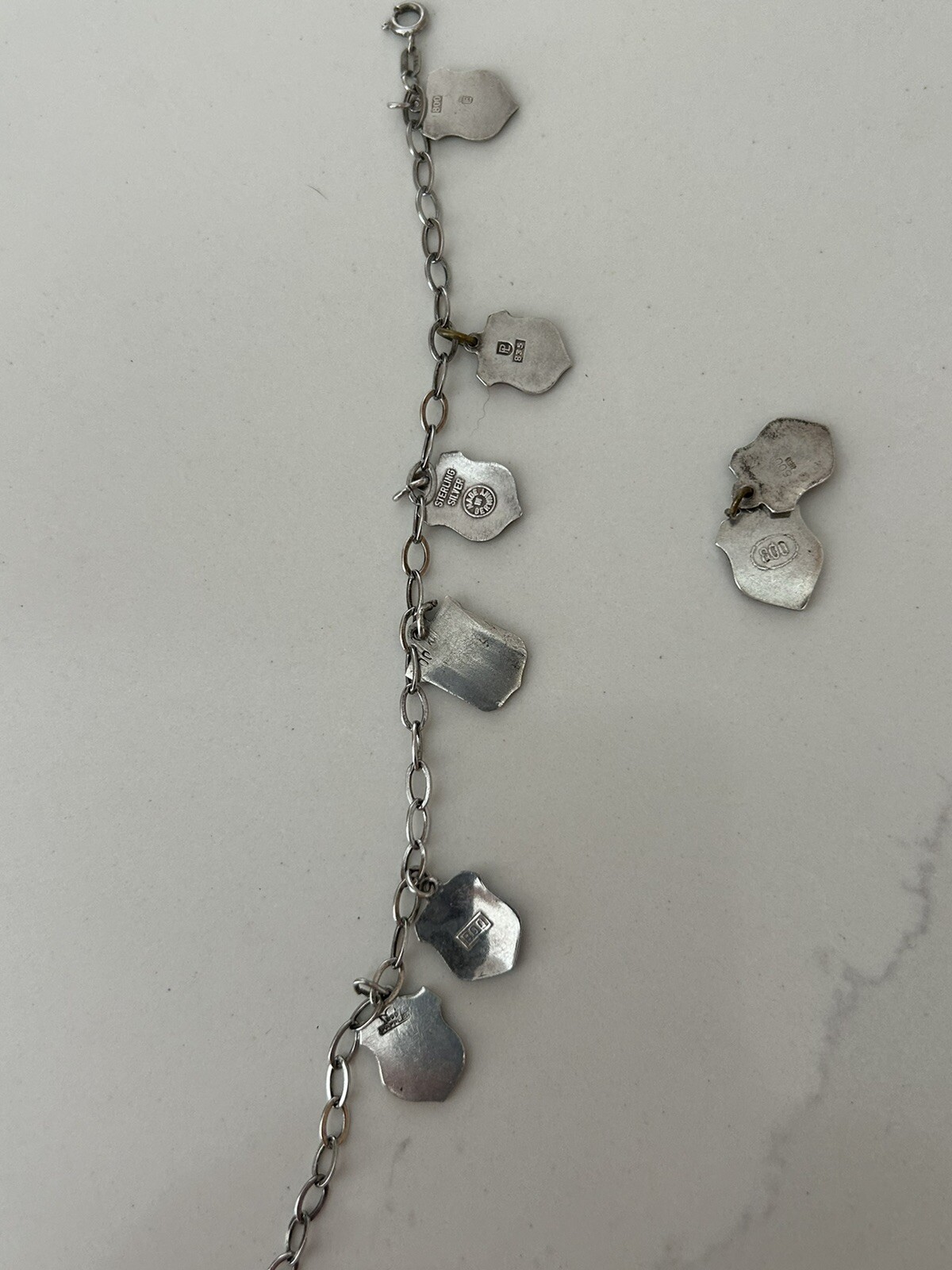 VINTAGE SOLID SILVER AND ENAMEL TRAVEL CHARM BRACELET6 COAT OF ARMS (8 TOTAL)