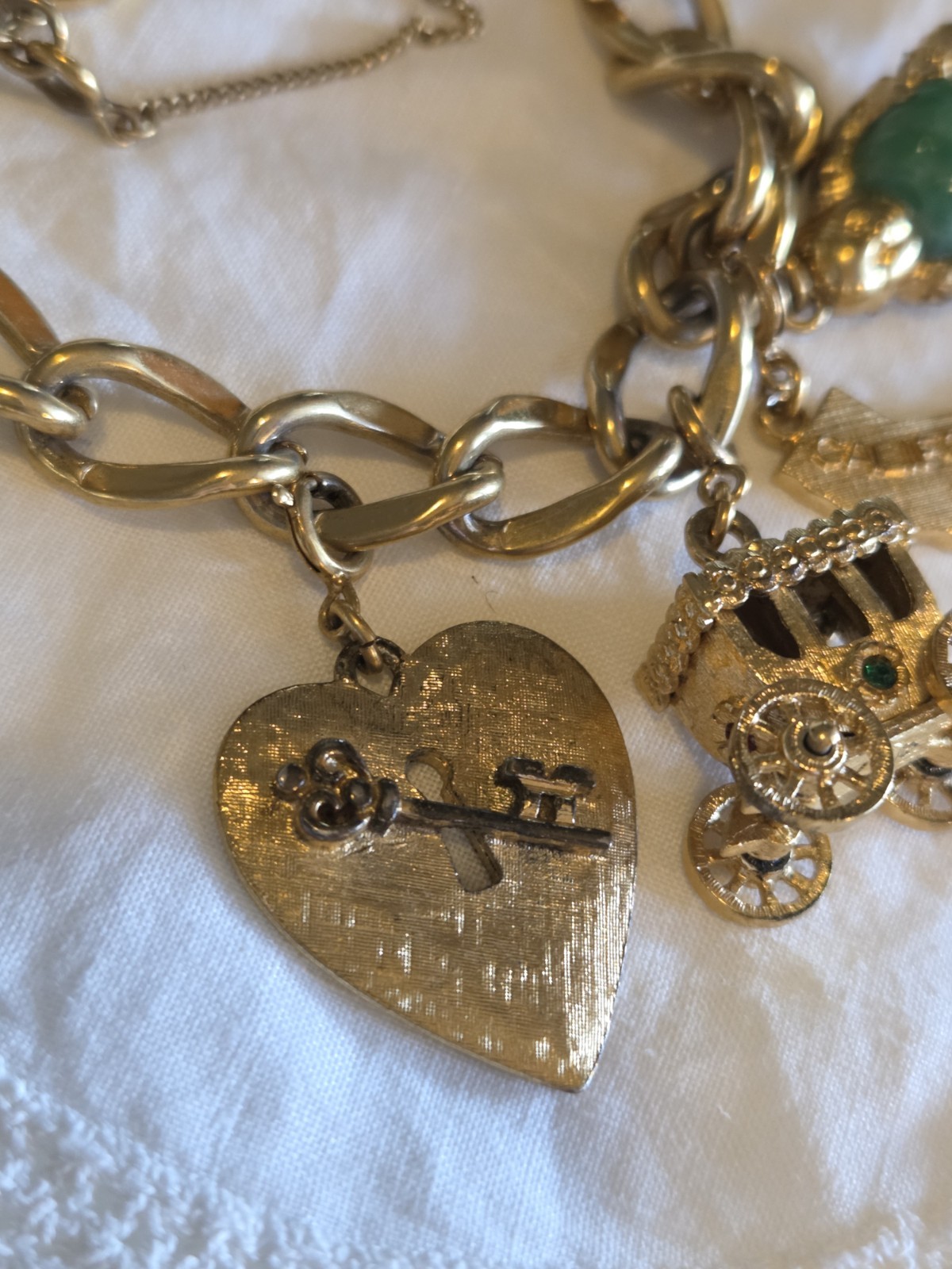 vintage Monet gold-tone charm bracelet features multiple detailed charms