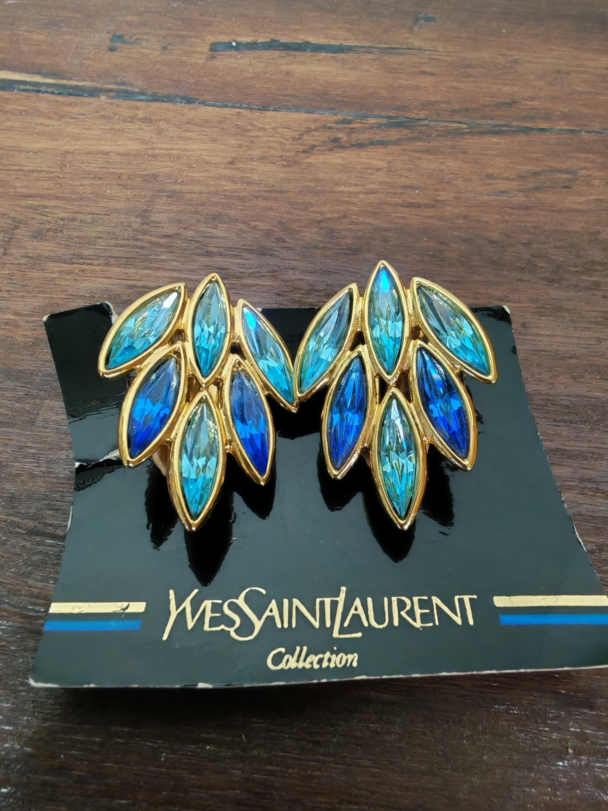 Yves Saint Laurent gold plated earrings, set with light blue and blue crystals