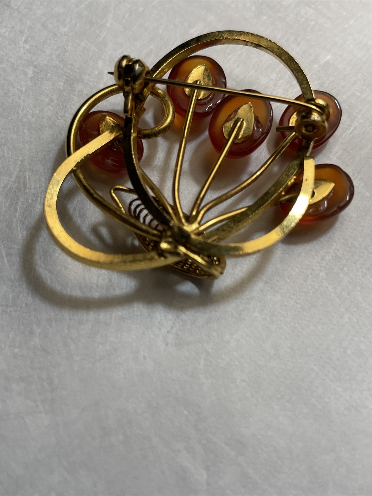 Vintage gold tone brooch with amber colored stones
