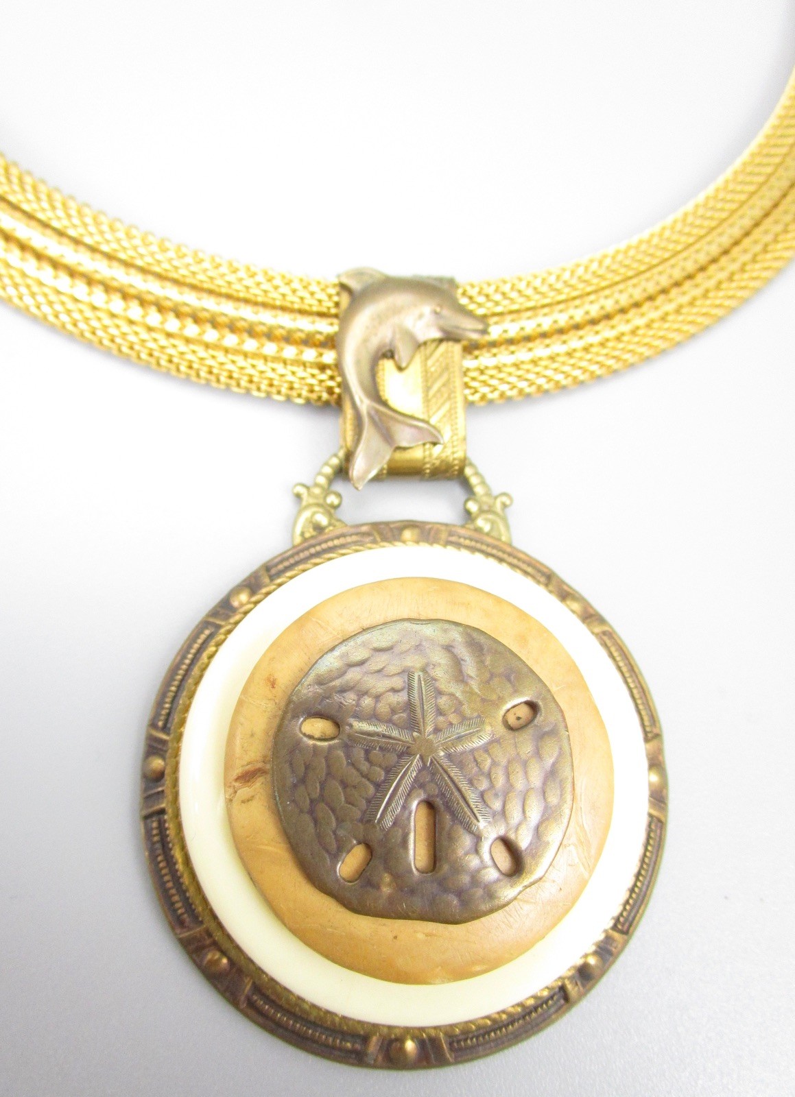 LOVELY PATRICE BRASS RESIN &  SHELL SAND DOLLAR DOLPHIN STATEMENT NECKLAC