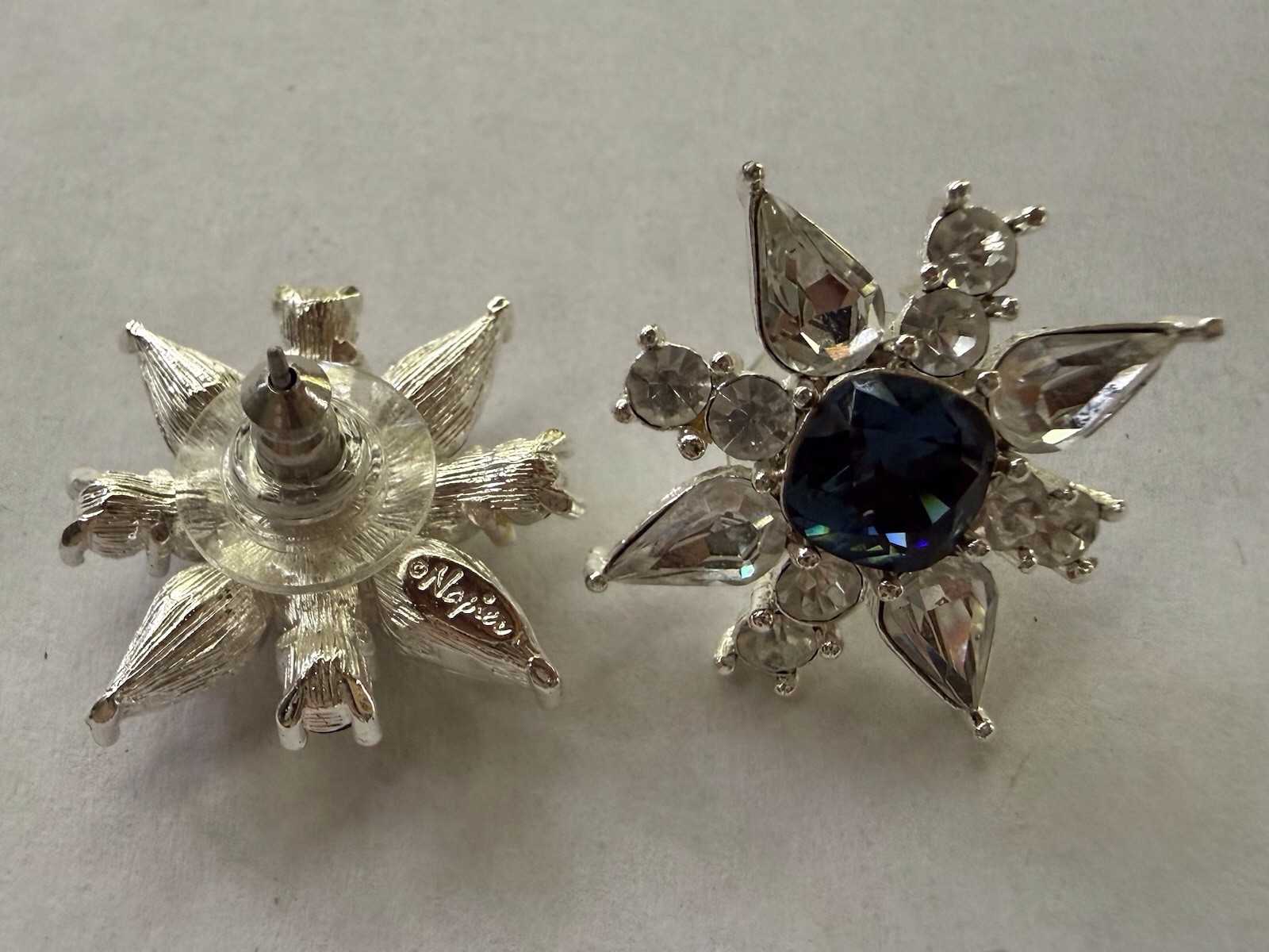 Napier pierced Silver Starburst Stud Earrings with Deep Blue Center .