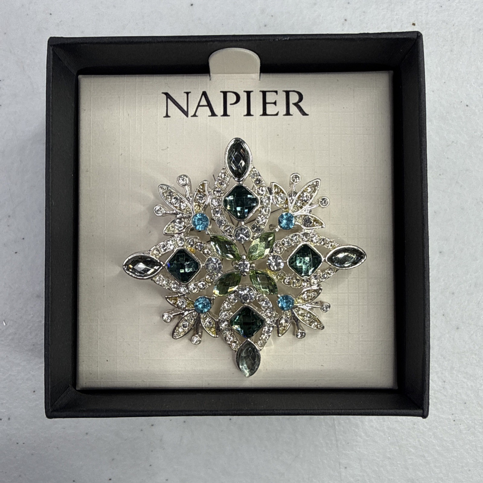 Napier silver-tone snowflake pin/brooch featuring blue and green rhinestones NOS