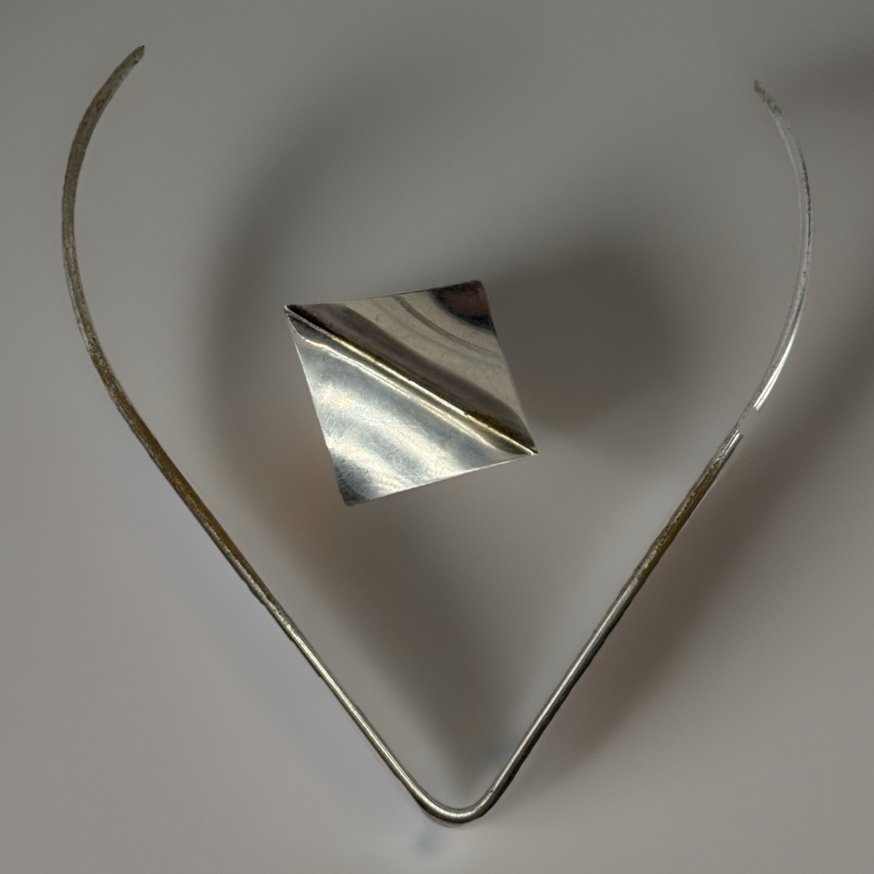Modernist Mid Century silver tone V neck choker Wire with 2 inch geometric charm