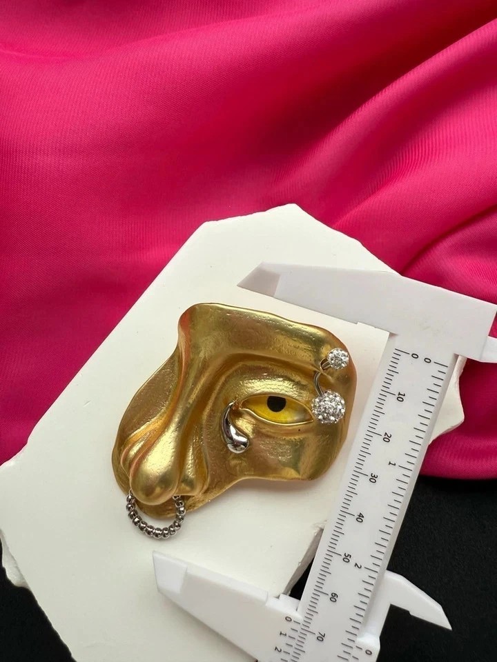 Schiaparelli yellow eye nose brooch with box